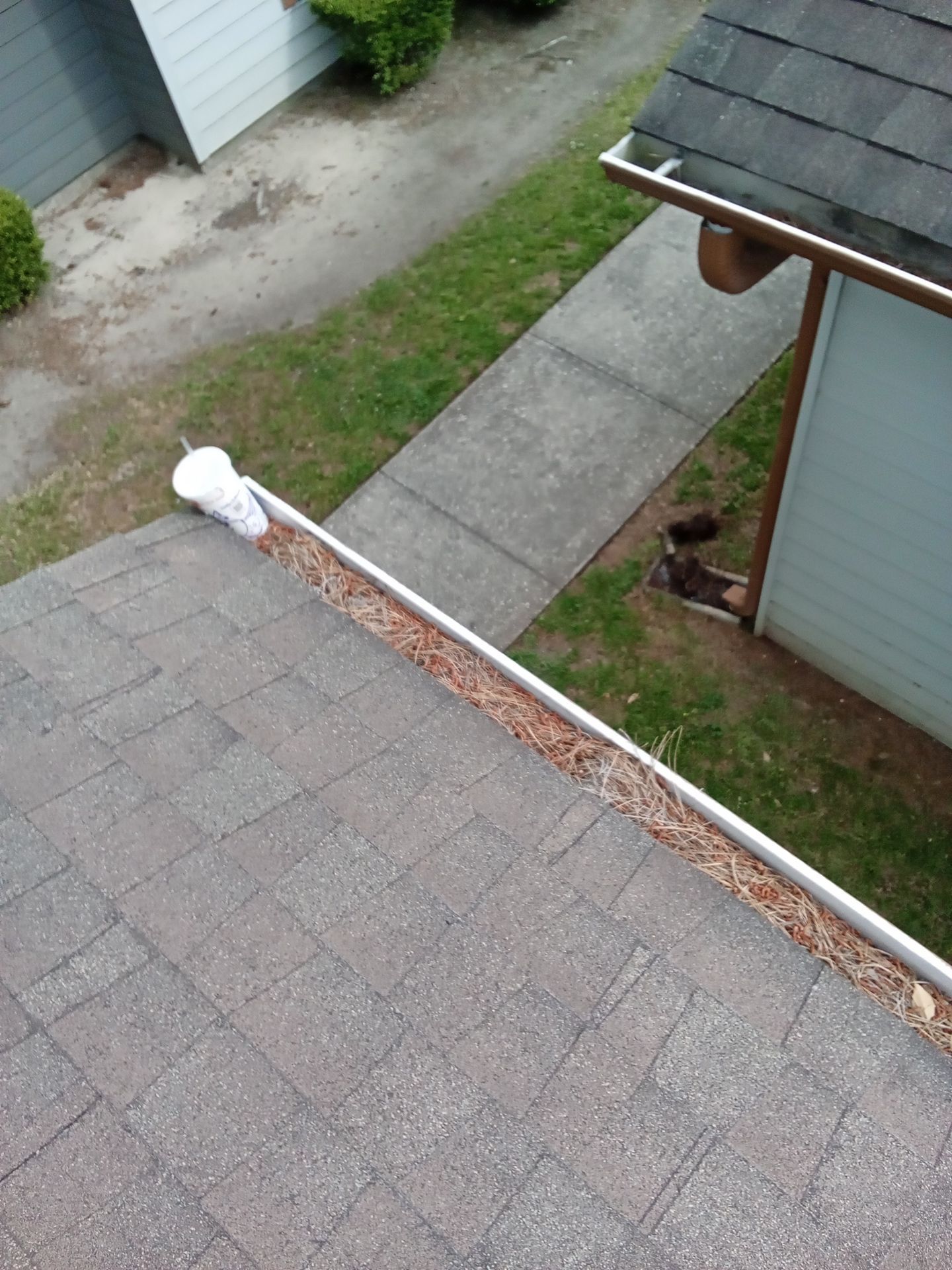 Commercial gutter cleaning Beaumont & Port Arthur before photo with filled gutters