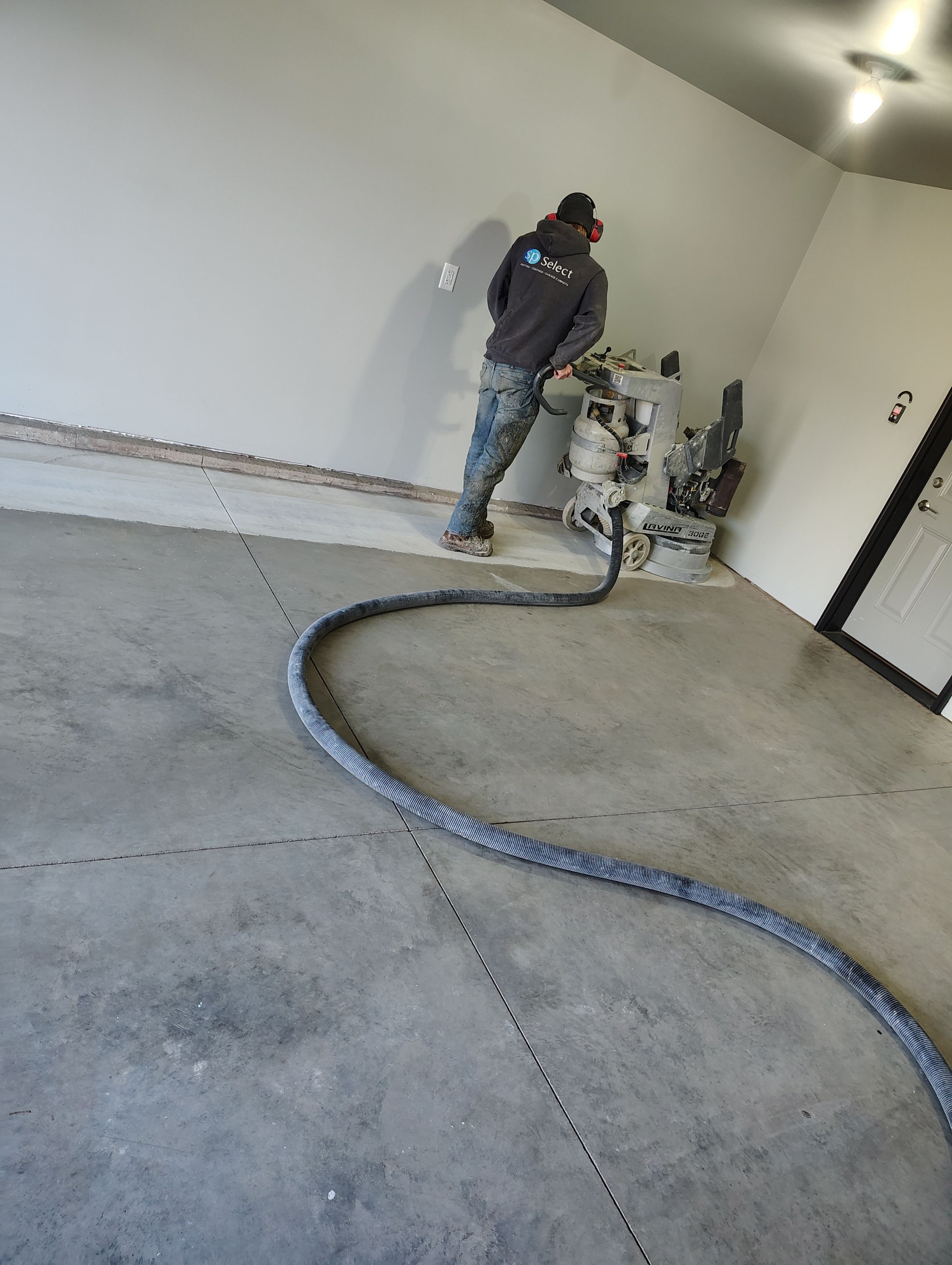 Custom Epoxy Garage Floor Coating Installation in Sioux Falls by Select Painting, Coatings & Garage Cabinets