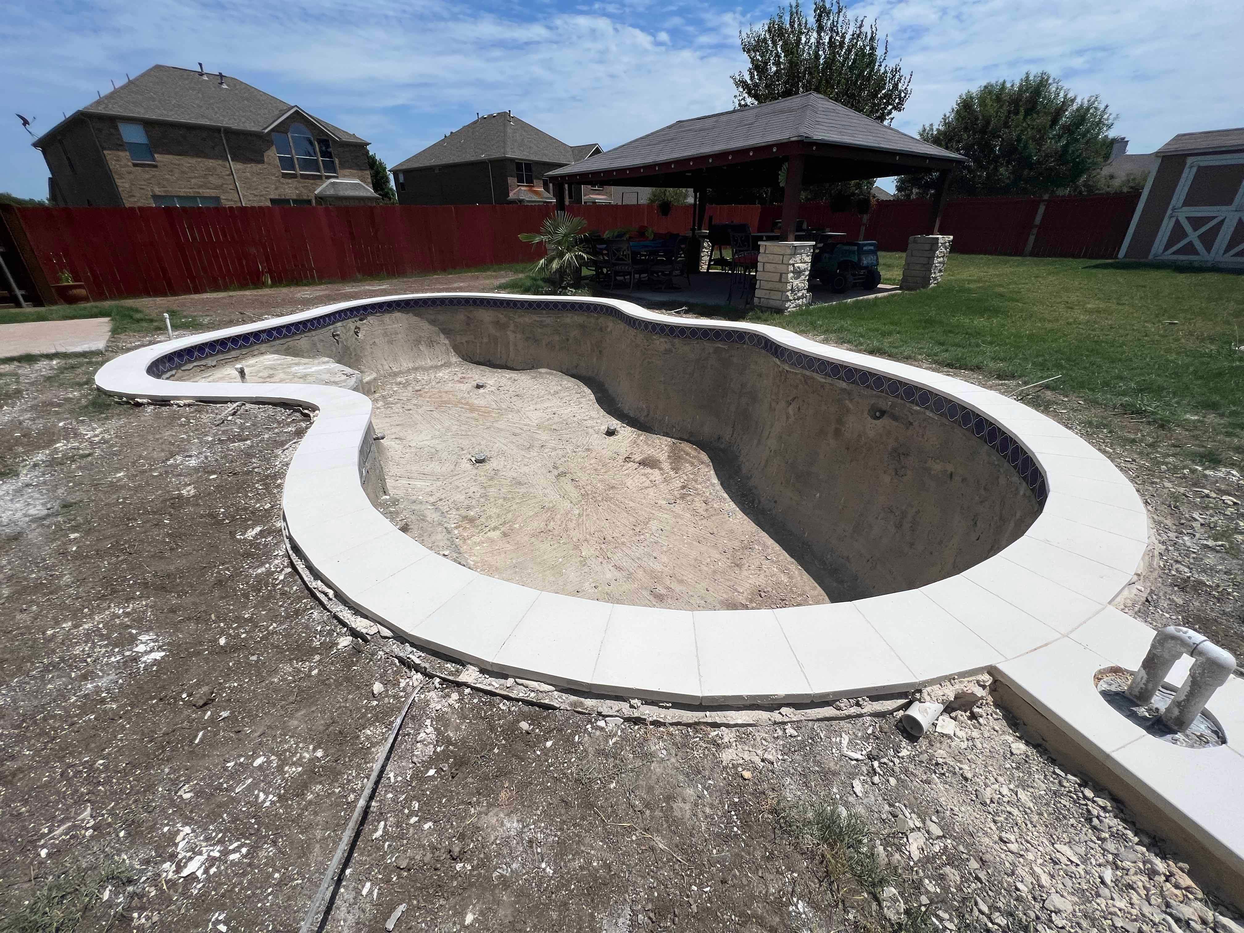 Freeform Pool with Tanning Ledge and Stone Decking by Pinnacle Pools and Spas - DFW