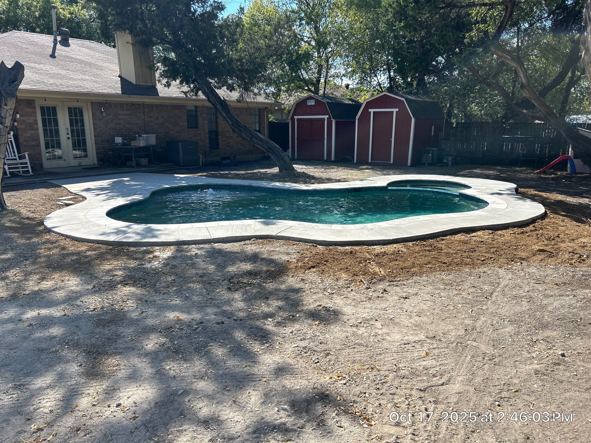 Freeform Pool Remodel with New Decking and Pebble Interior by Pinnacle Pools and Spas - DFW