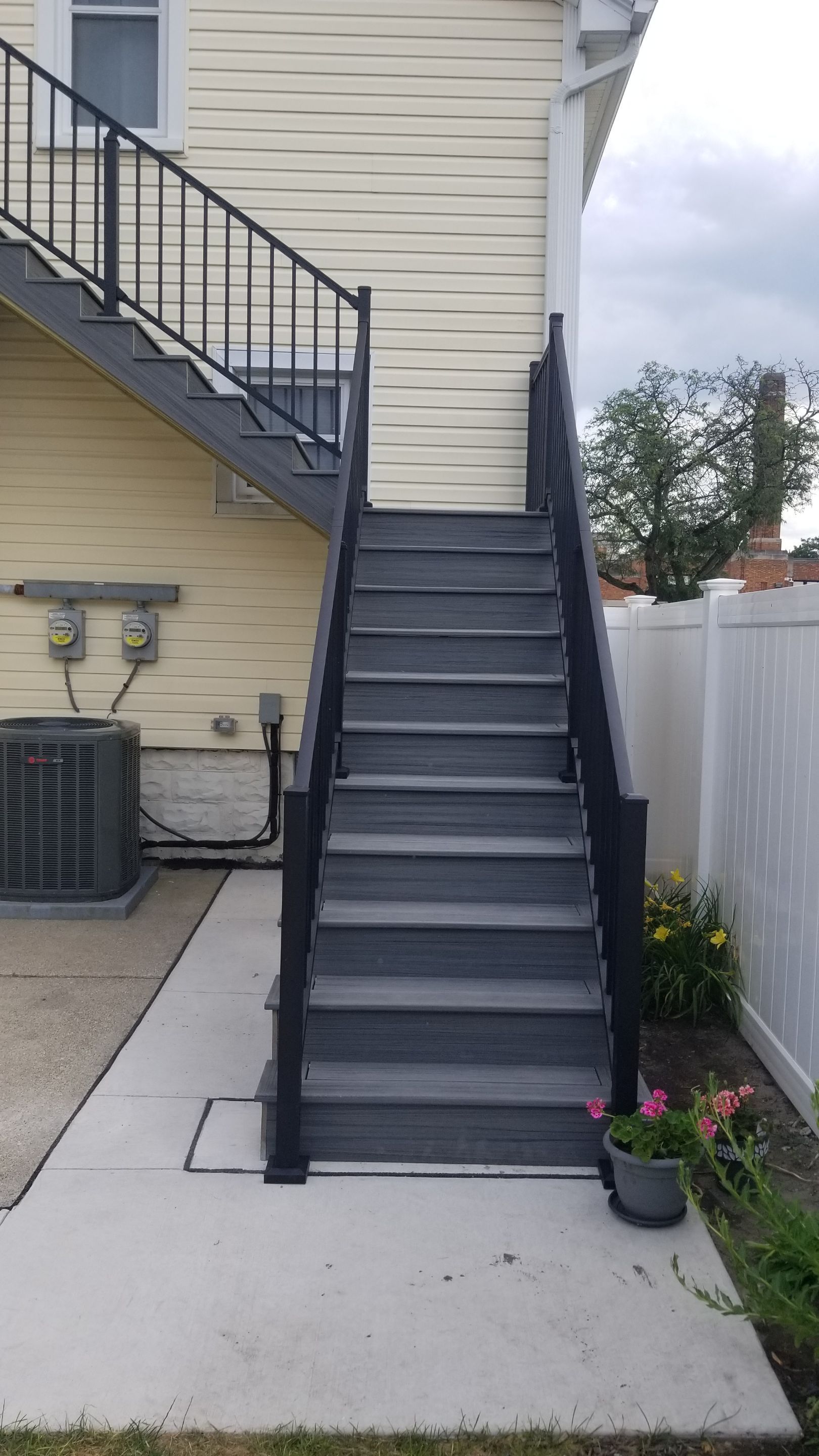 Rebuild balcony flat roofing TREX decking stairway and Railings in Wyandotte, MI by Northwest Construction 