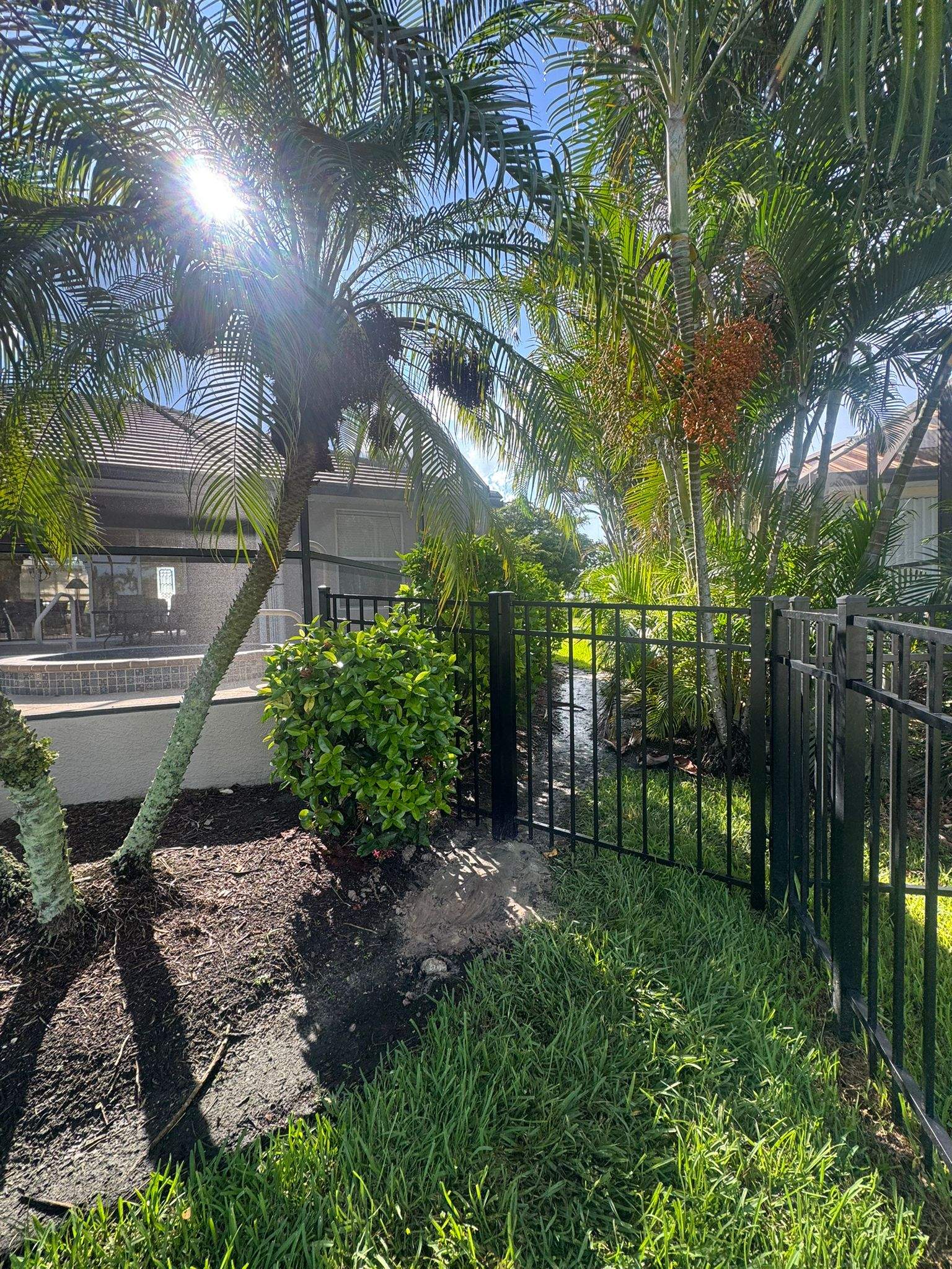 Black Aluminum Fence Installation Along Punta Gorda Canal by True Fence LLC