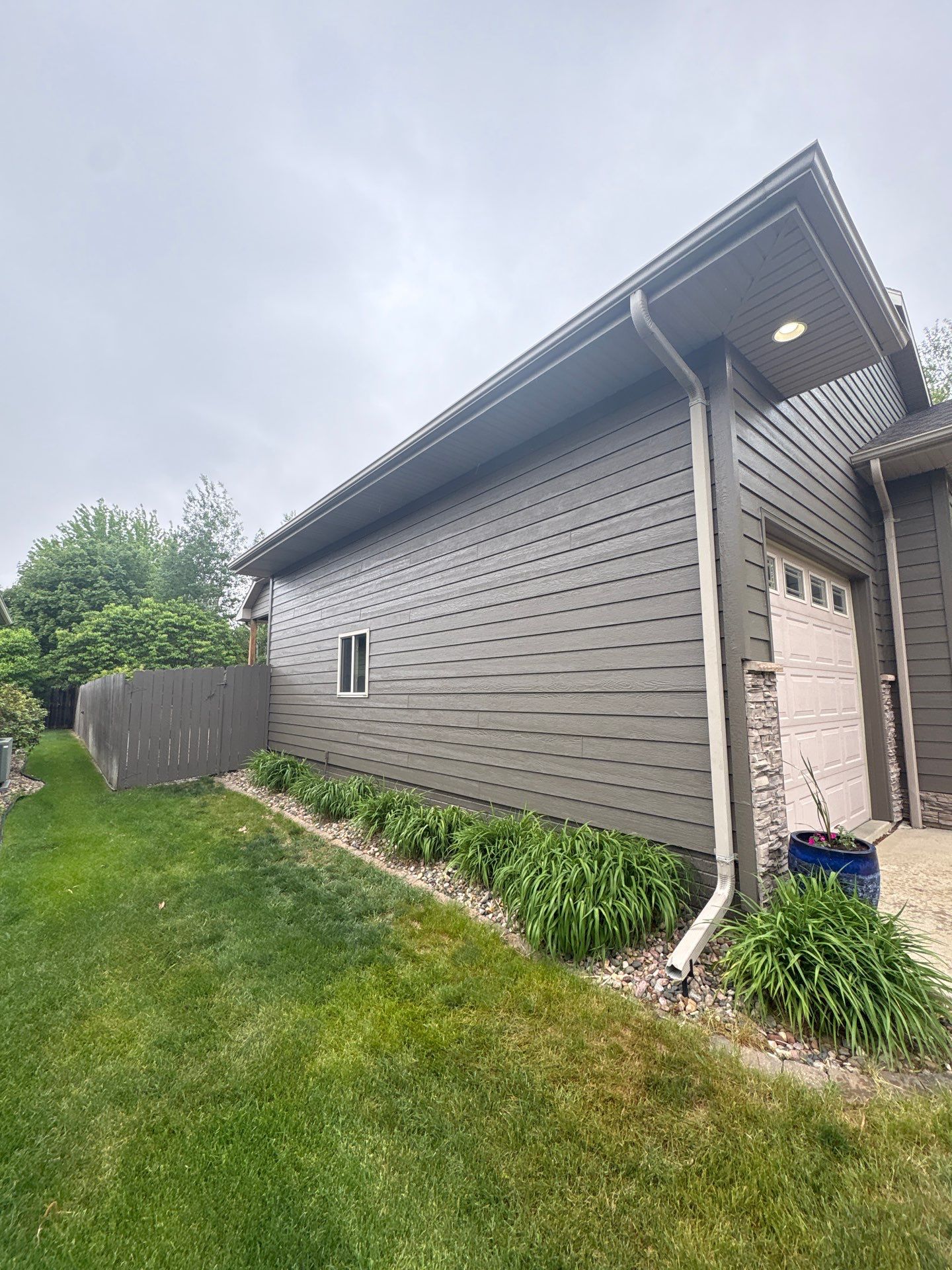 Sioux Falls Residential Exterior Update and Flagstone Pool Deck by Select Painting, Coatings & Garage Cabinets