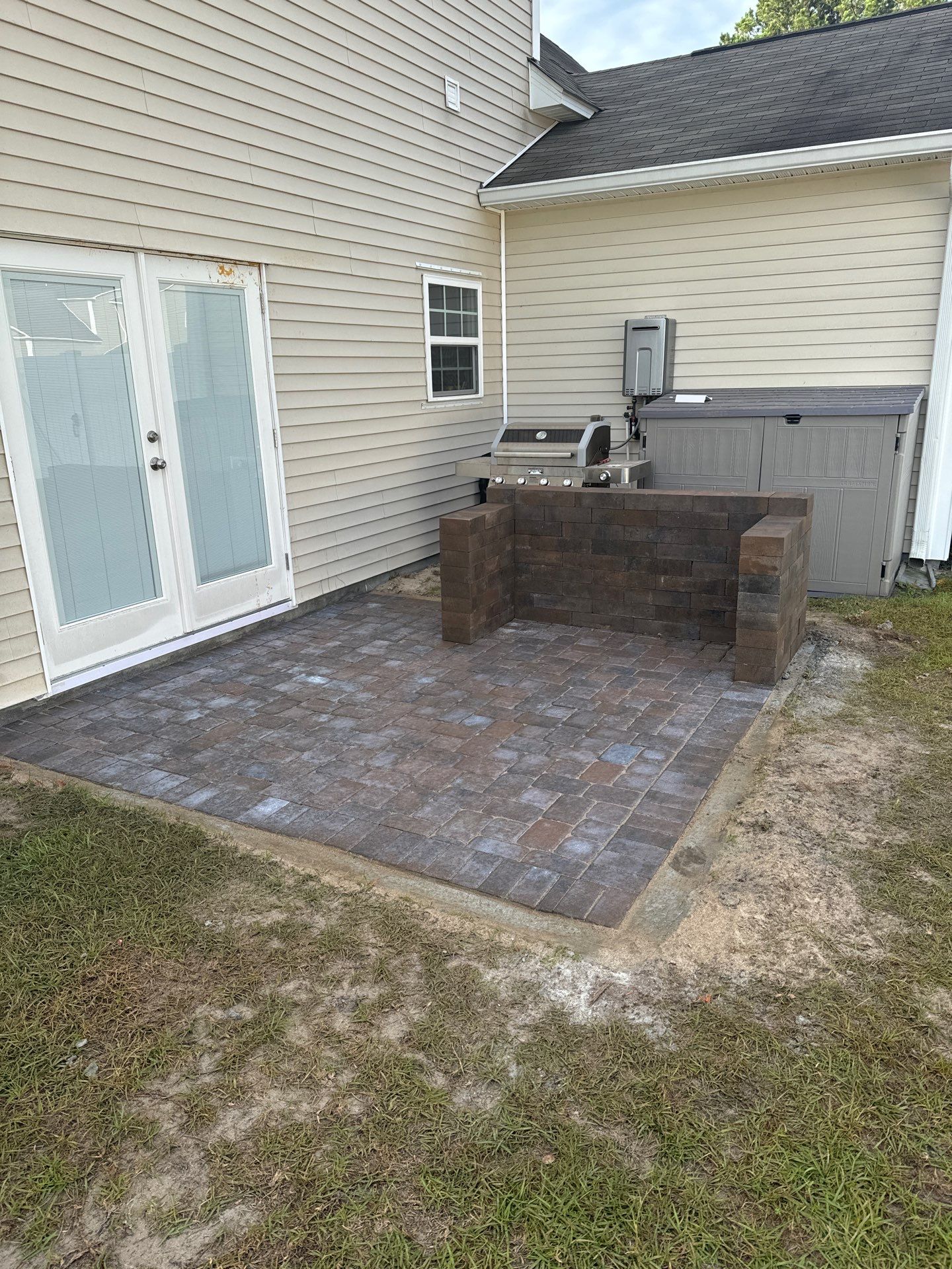 Custom Herringbone Paver Patio and Retaining Wall in Bluffton by Lowcountry Scapes, LLC