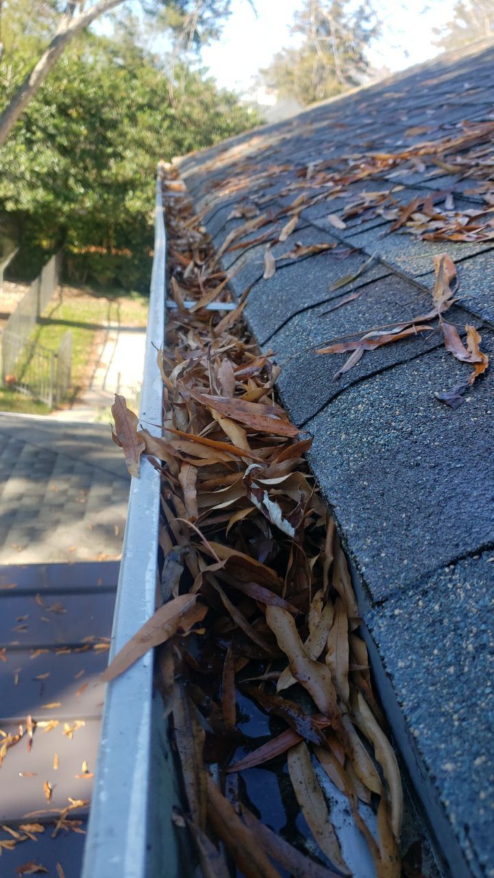 Sara Gutter cleanout using water by Power Wash Masters LLC