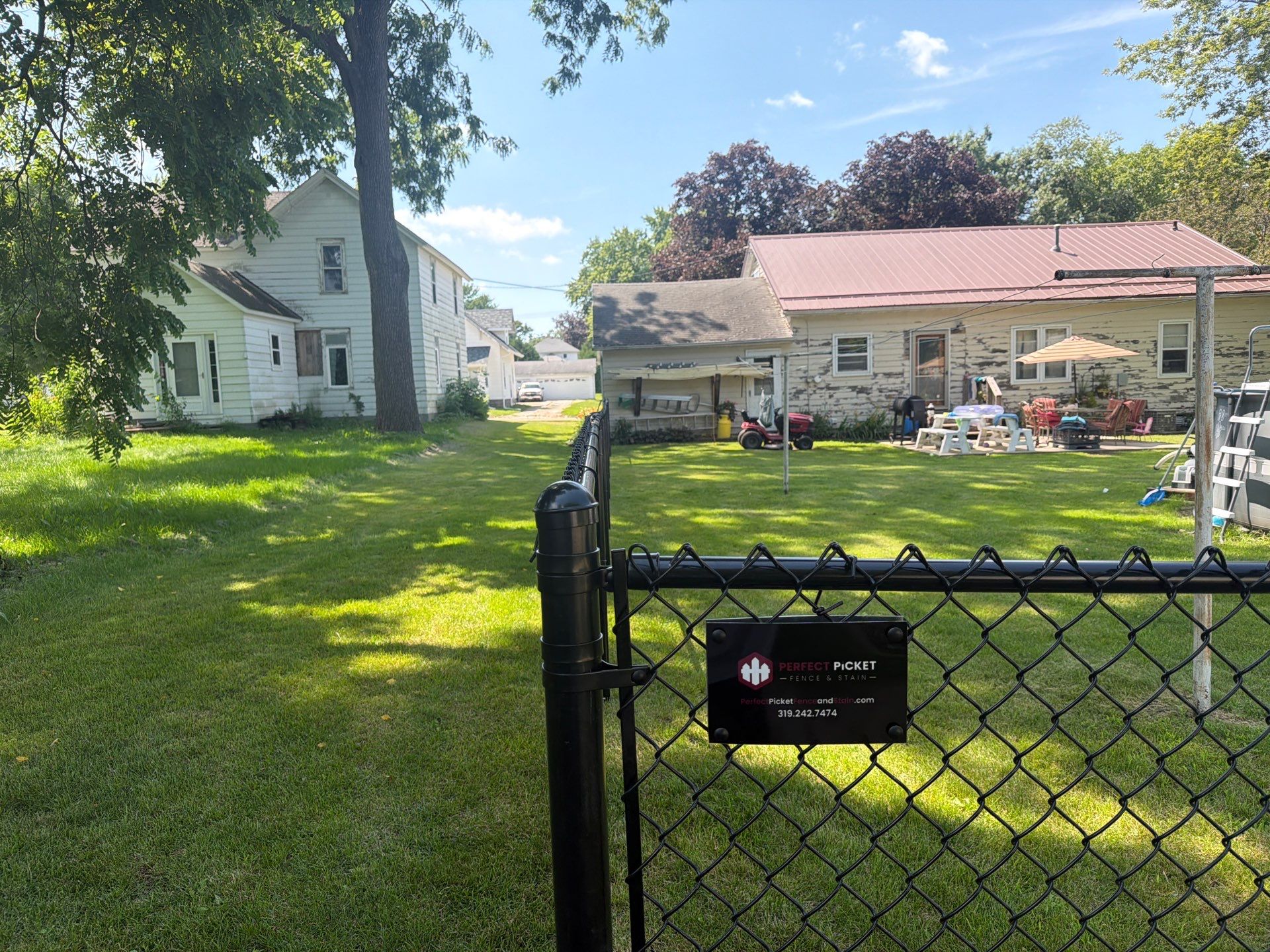 Black Chain Link Backyard Fence Installation in Tripoli, IA by Perfect Picket Fence and Stain