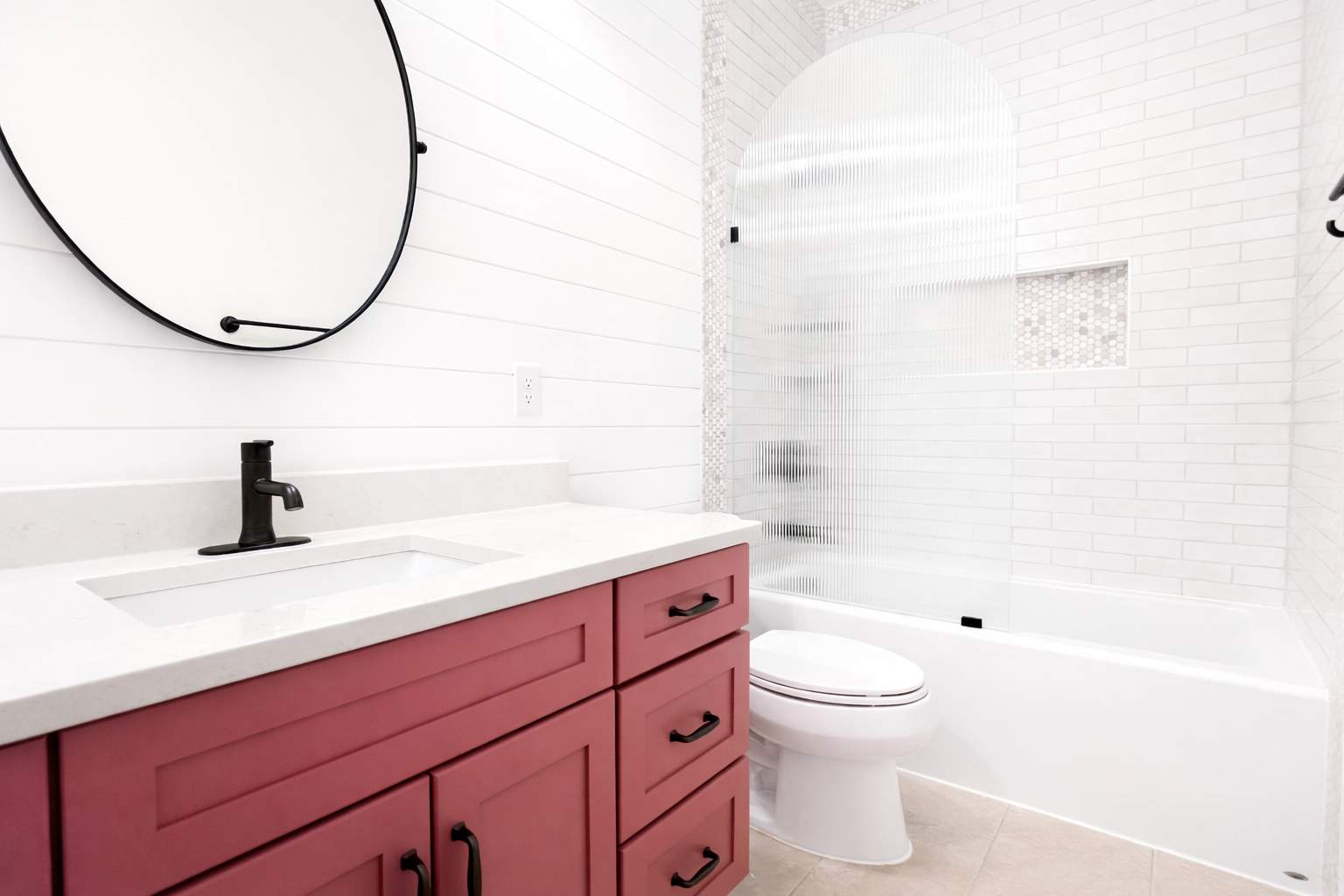Stone Oak Hall Bathroom Remodel with Pink Vanity and Curved Shower Glass by Legacy Bath and Kitchen
