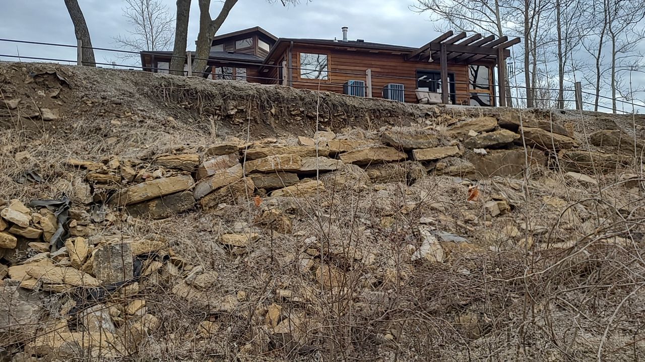 Supporting back of home with backfill at edge of steep creek by LAND ESCAPES LLC