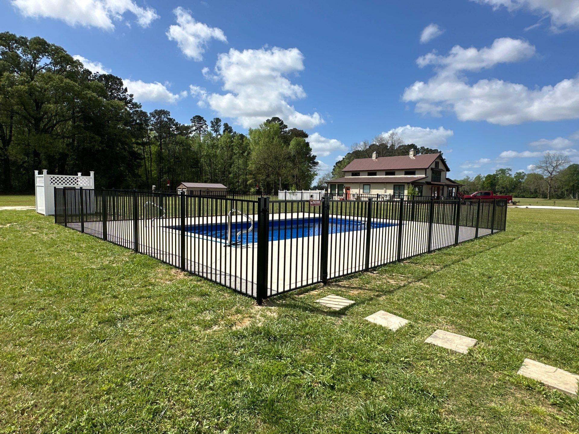 Black Aluminum Pool Fence Installation in Whiteville, NC by Superior Fence and Rail