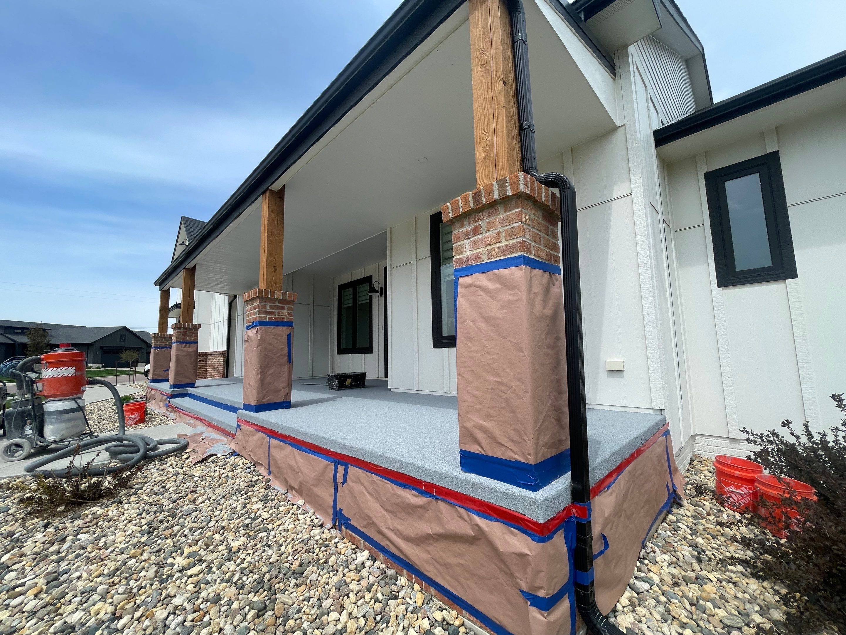 Grey Speckled Concrete Porch Coating for Sioux Falls Home by Select Painting, Coatings & Garage Cabinets