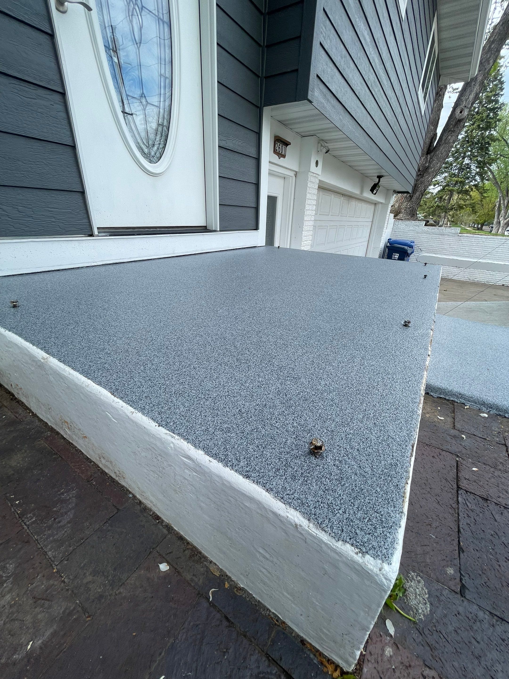 Grey Polyaspartic Porch and Stair Resurfacing in Sioux Falls by Select Painting, Coatings & Garage Cabinets