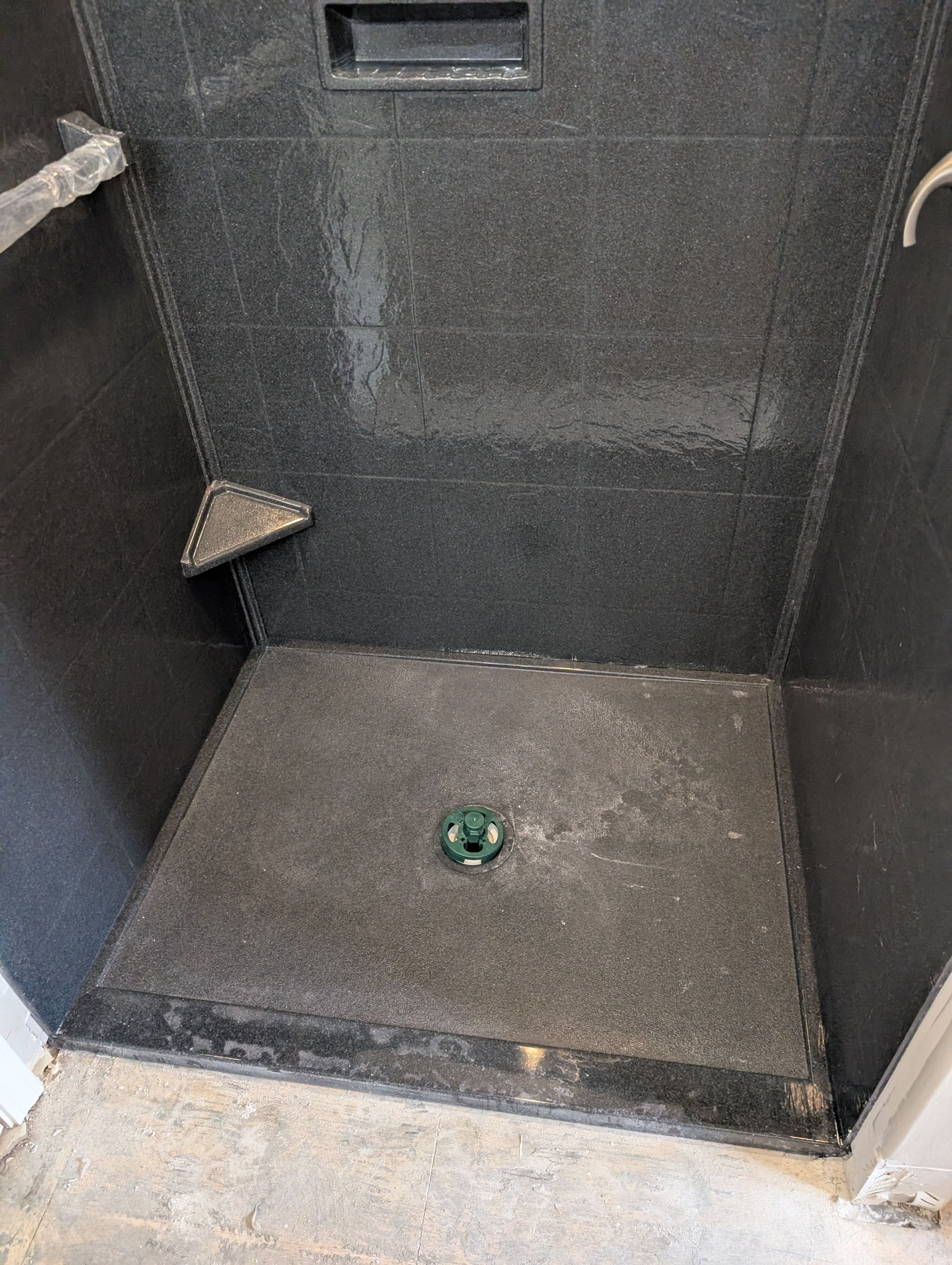 Master Bathroom Renovation Featuring Dark Textured Shower Panels in Branson West by Kitchen Works LLC