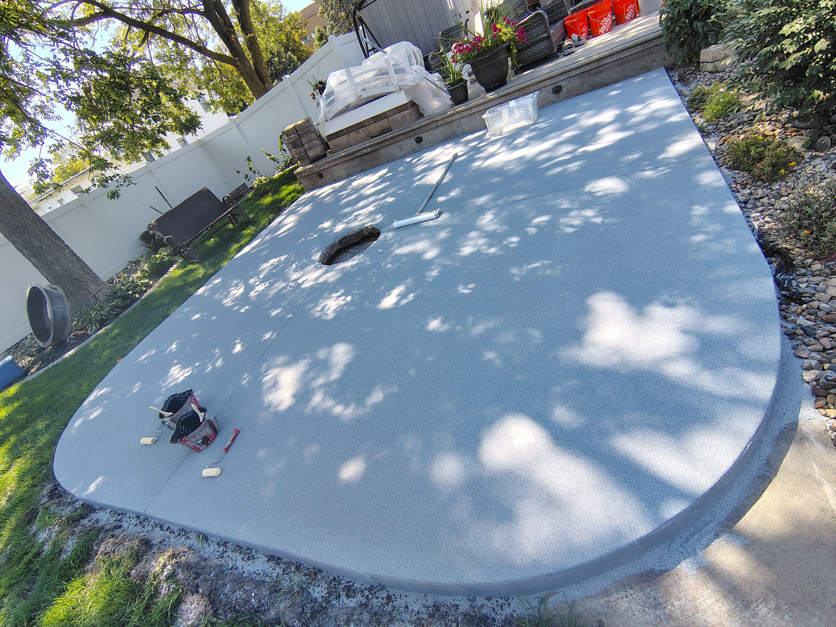 Custom Garage Floor Coating and Backyard Patio Refinishing in Tyndall by Select Painting, Coatings & Garage Cabinets