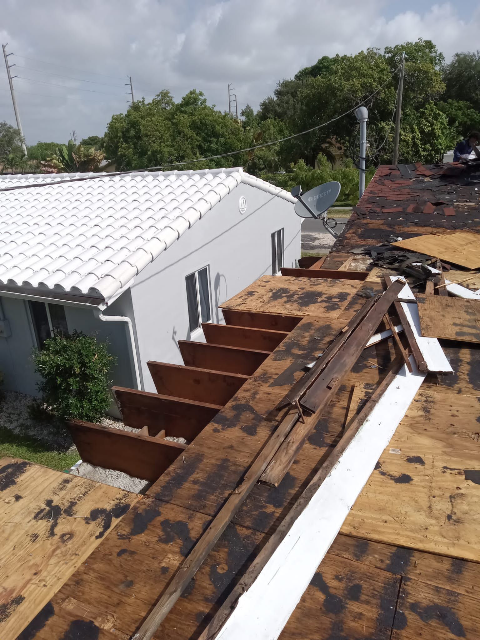 Standing Seam Metal & Flat Re-Roof using 1.5" Nail Strip 24ga Black Matte Kynar Coated Standing Seam Metal Panels by Morton Roofing, Inc.