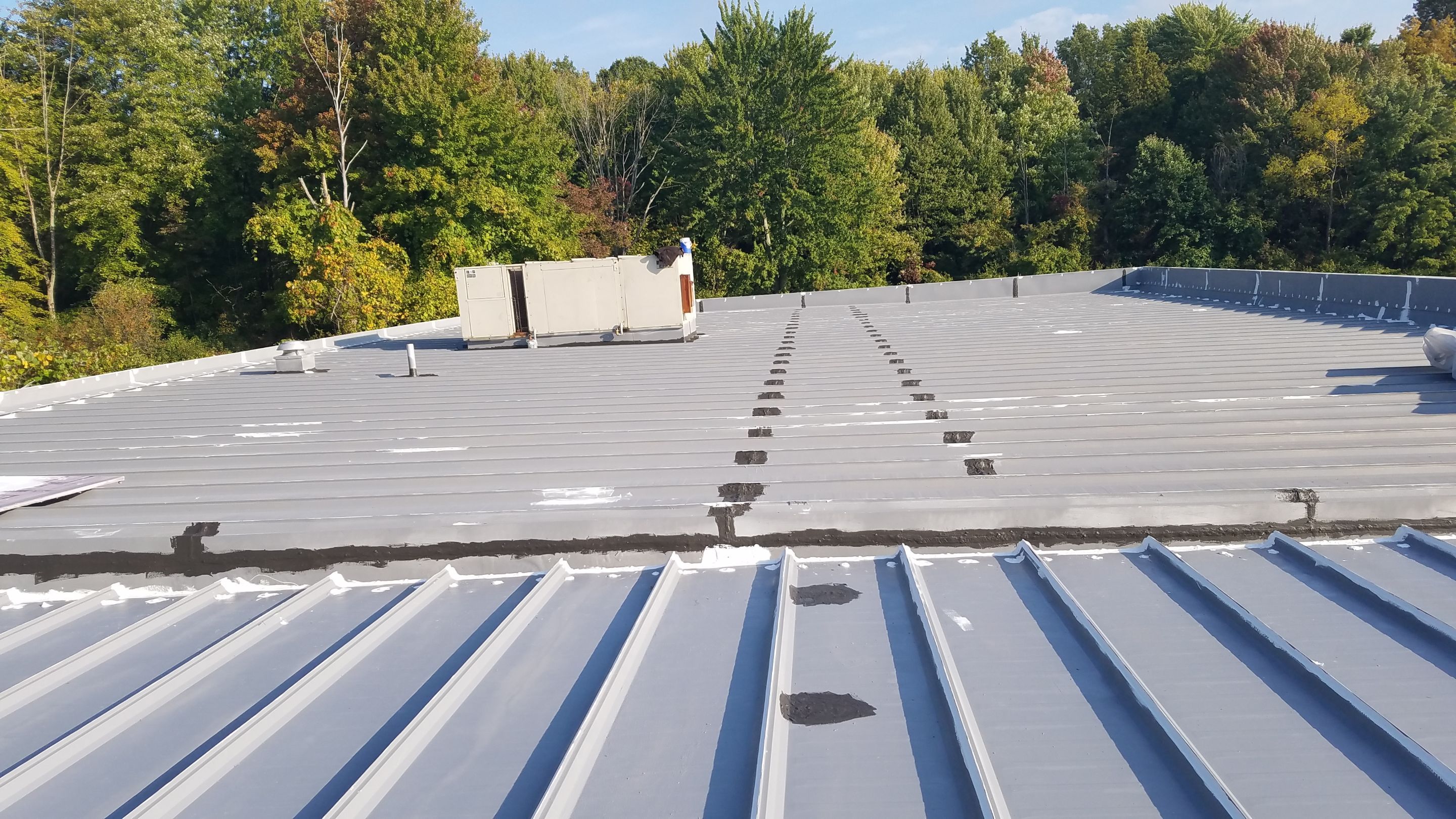 Commercial Metal Roof Coating by Gold Star Roofing LLC