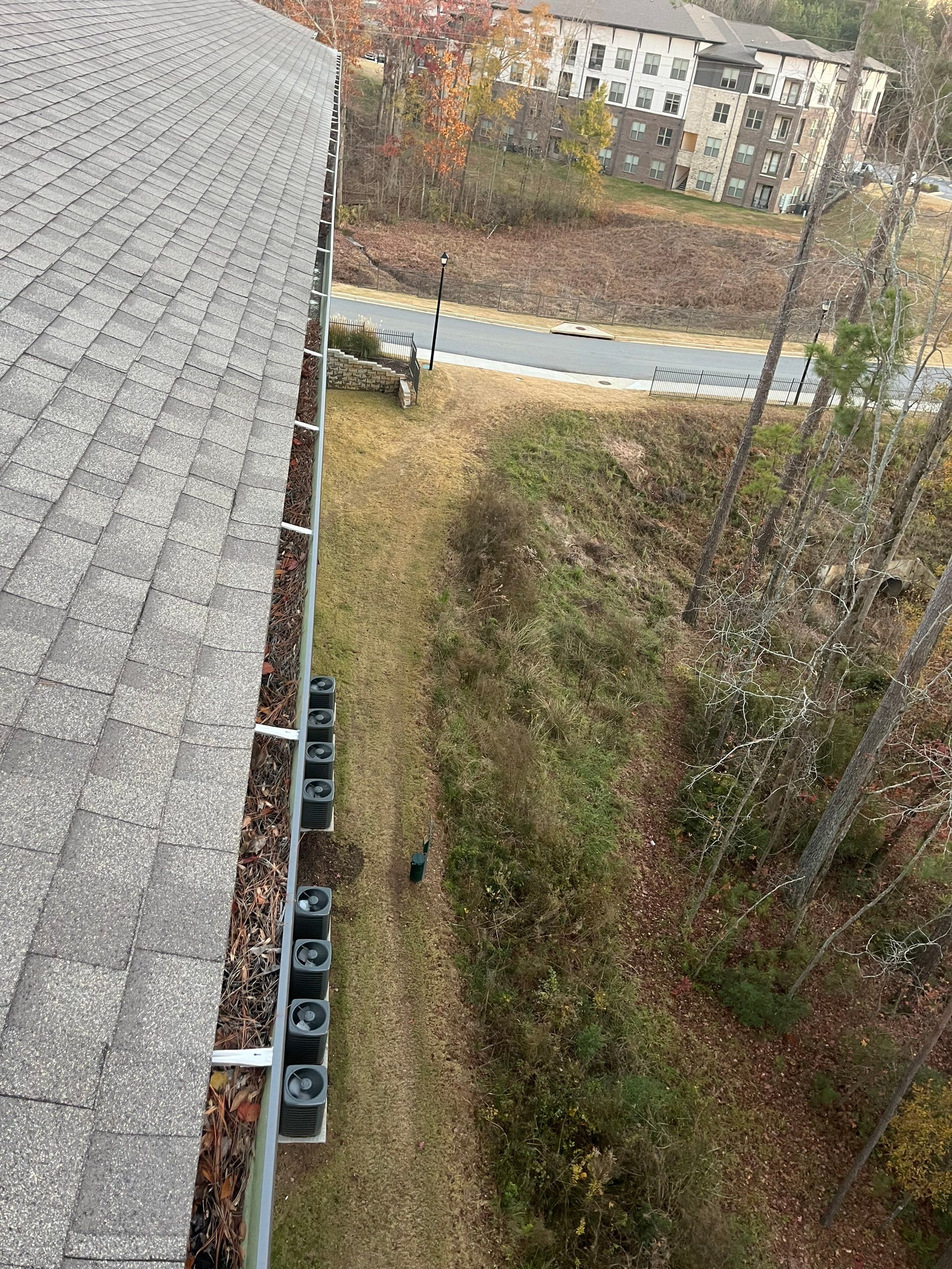 HOA gutter cleaning in Newnan, GA, NC,before  photo showing full gutters.