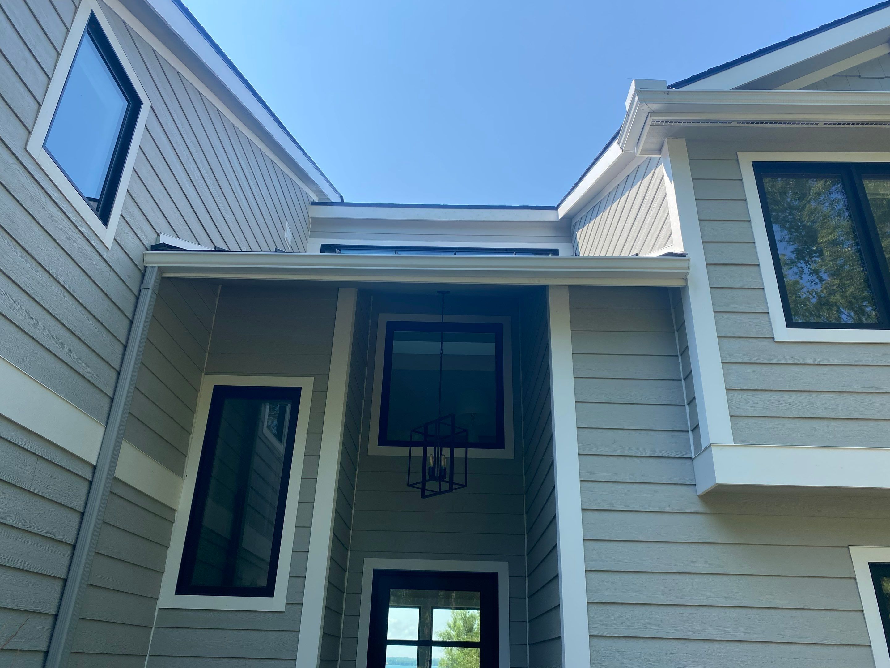 Off-White Aluminum Gutter and Downspout Replacement in Charlevoix by Rainbow Seamless Systems
