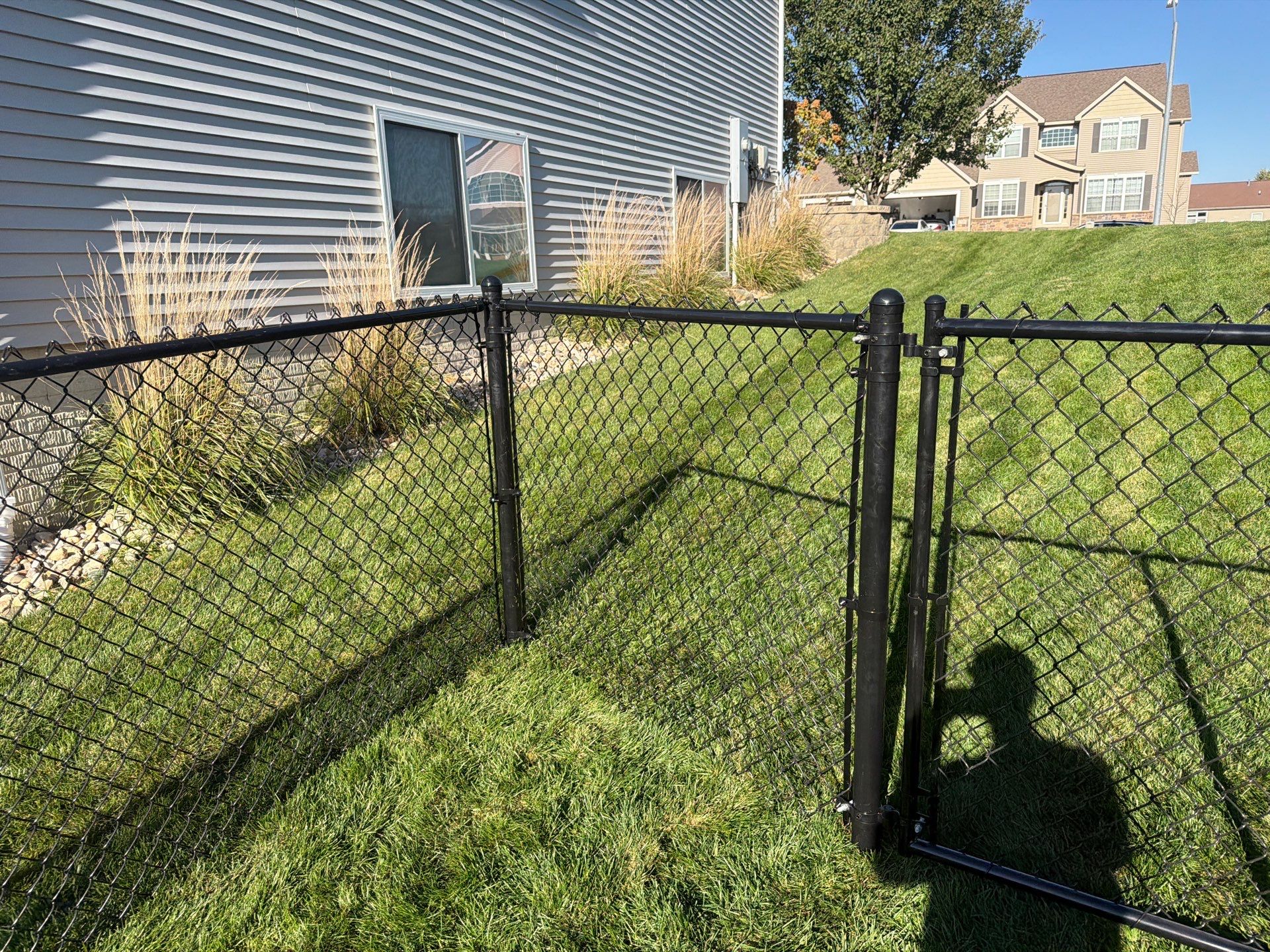 Black Vinyl-Coated Chain Link Fence Installation in Cedar Falls by Perfect Picket Fence and Stain