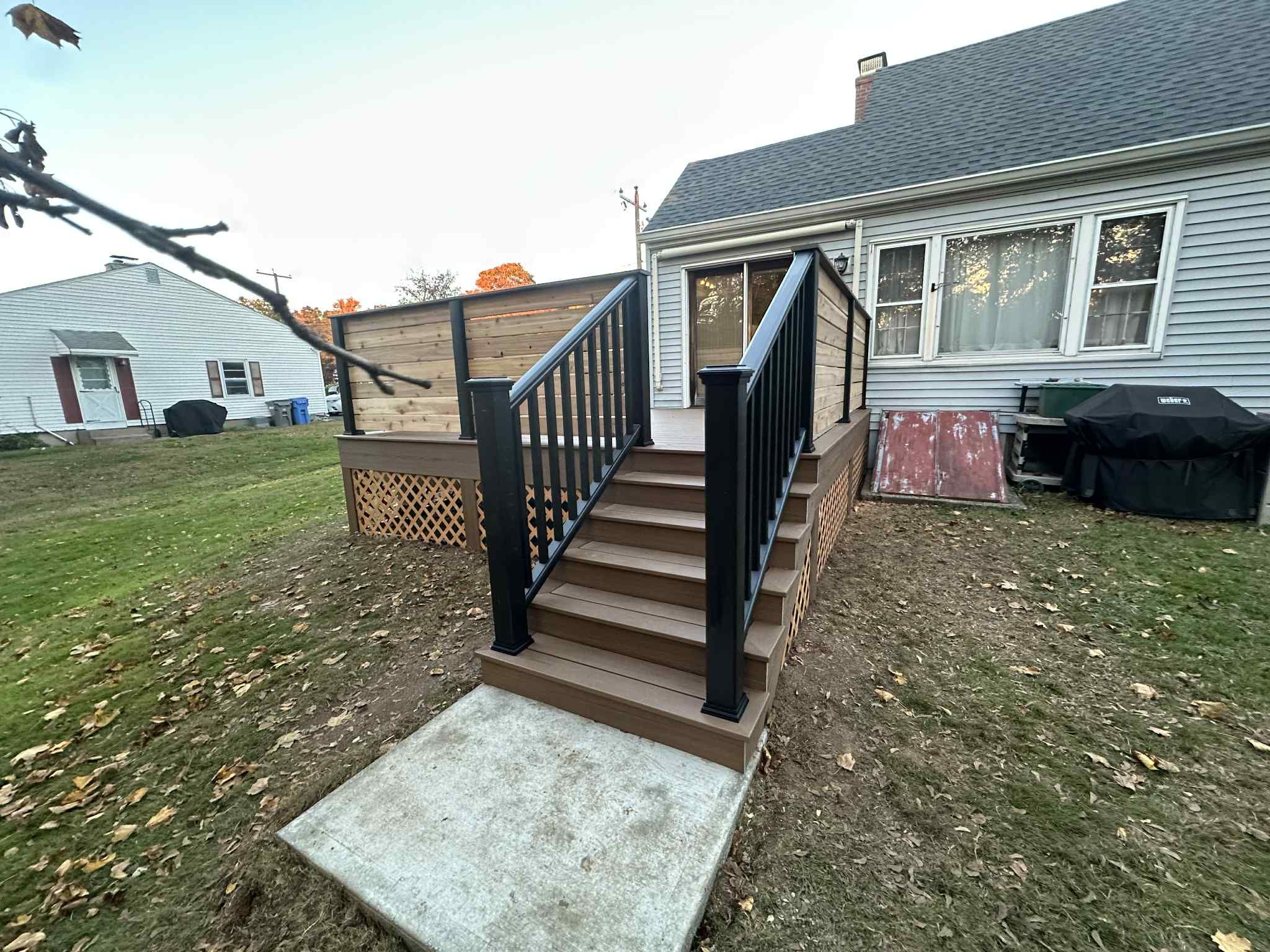 Deck Replacement with Trex Lineage Jasper, Custom Railings and Trex colored fascia by DiGiorgi Roofing and Siding Inc
