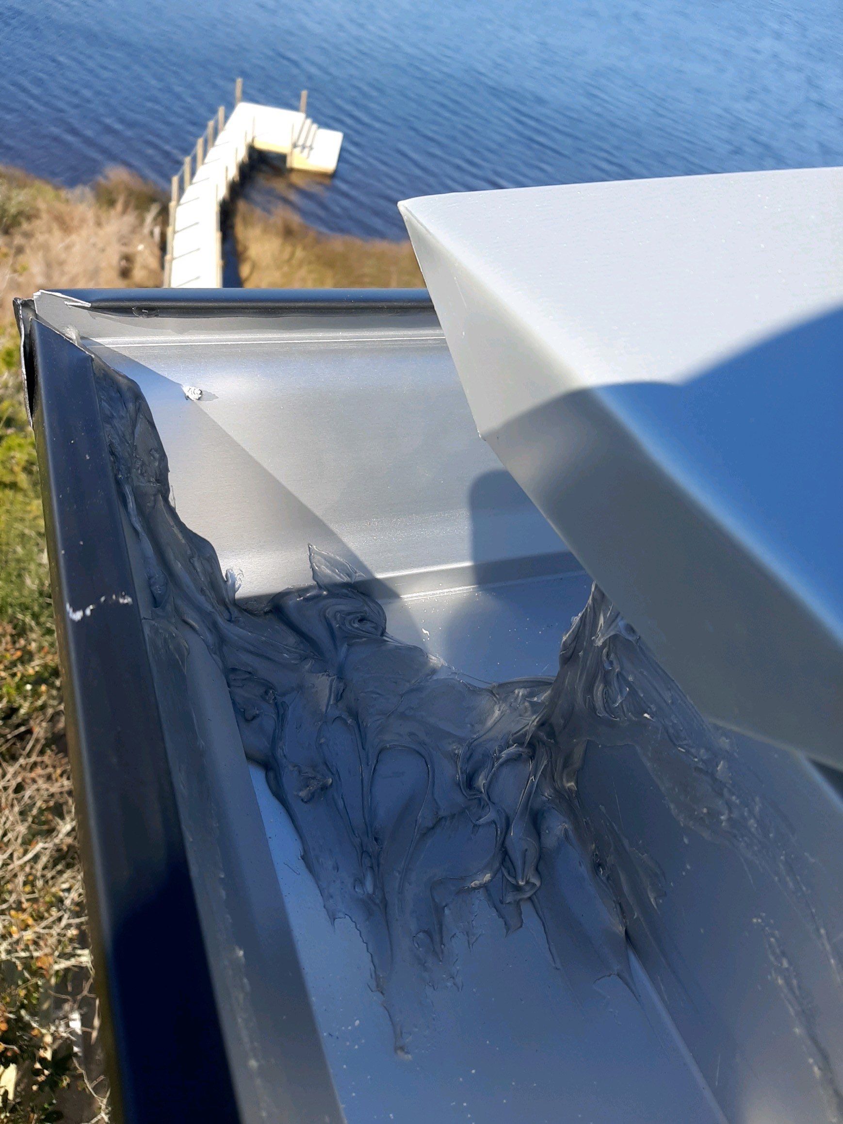 Seamless Gutter Installation Using Black Half Round Seamless Gutters by Gutter Professors