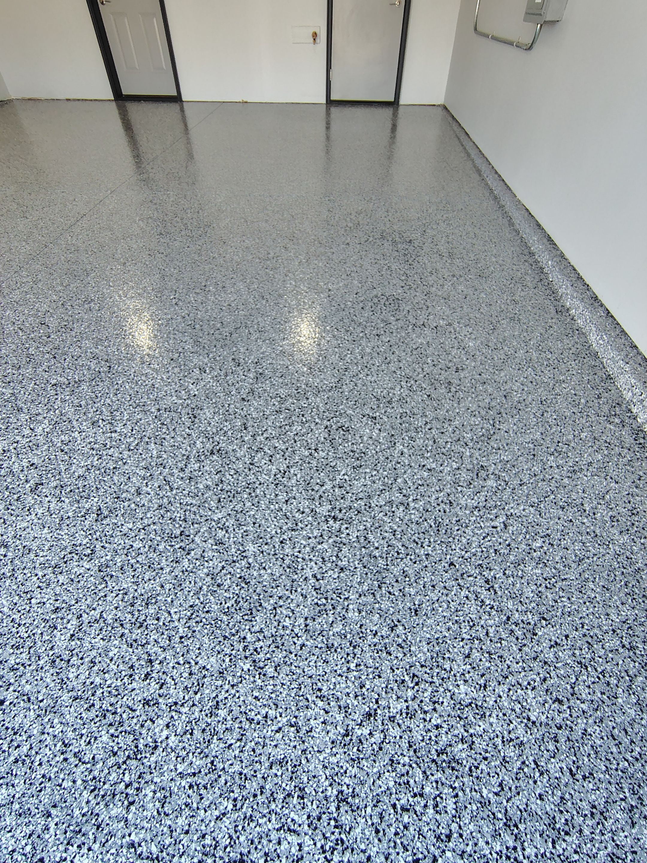 Custom Epoxy Garage Floor Coating Installation in Sioux Falls by Select Painting, Coatings & Garage Cabinets