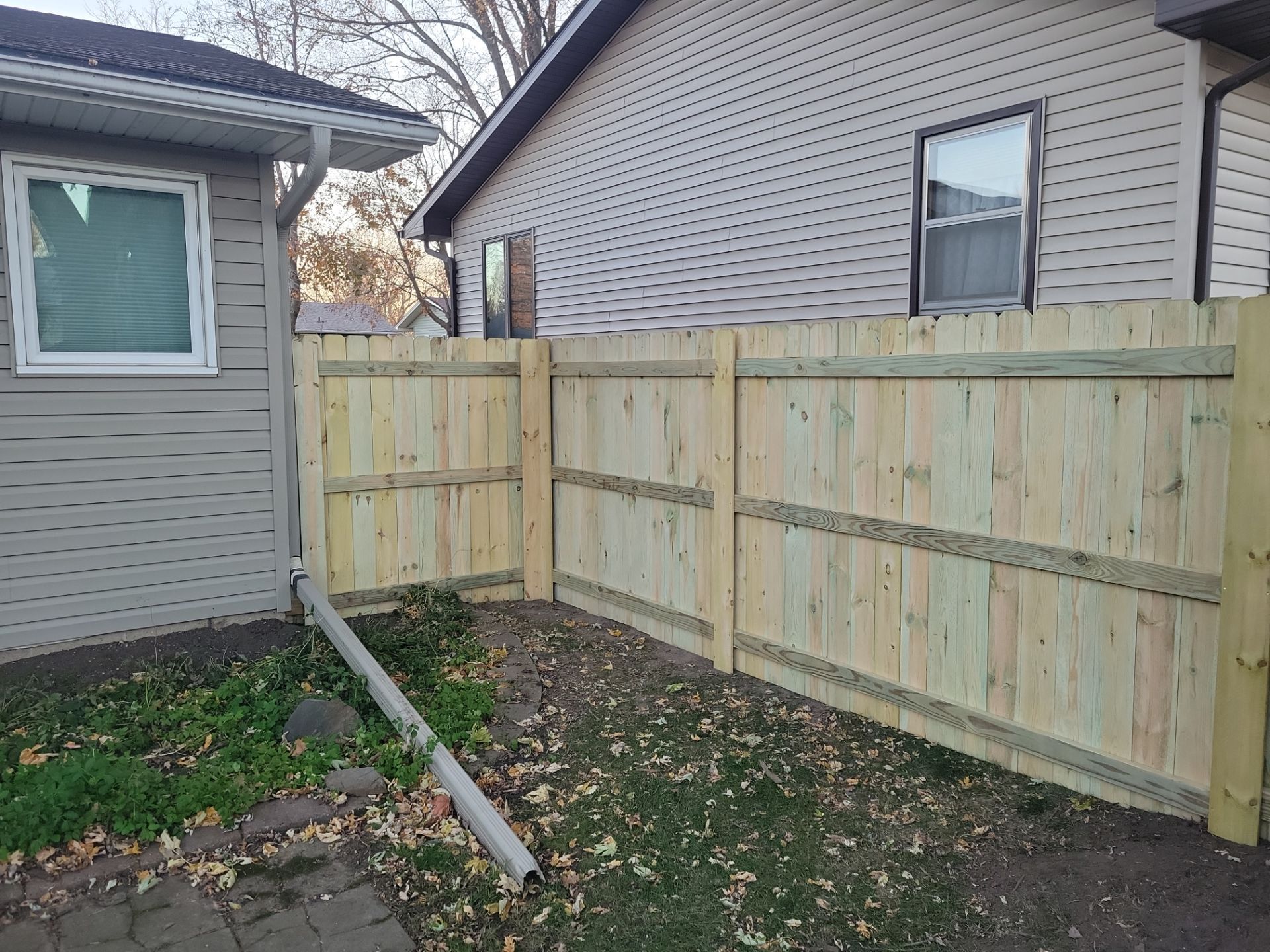 New Pressure-Treated Wood Privacy Fence and Gate in Charles City by Perfect Picket Fence and Stain