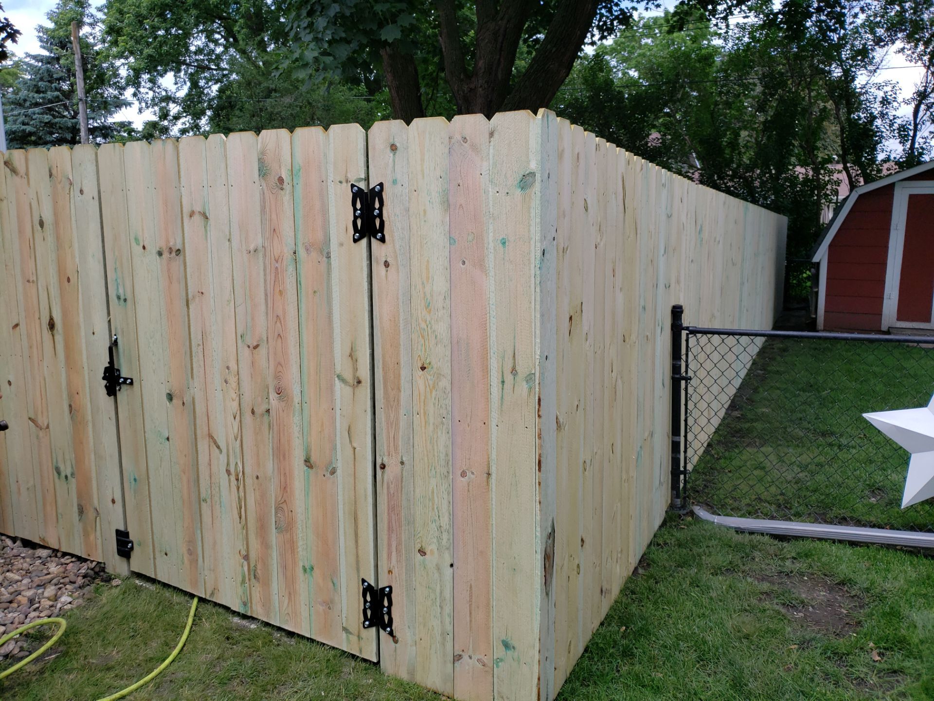 Custom Wood Privacy Fence Installation for Charles City Backyard by Perfect Picket Fence and Stain