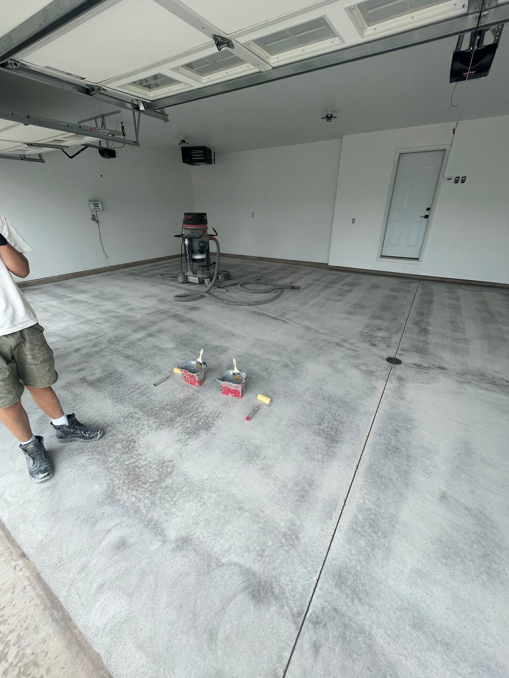Grey Flake Epoxy Garage Floor Coating in Sioux Falls by Select Painting, Coatings & Garage Cabinets