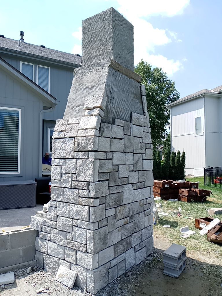 Back Yard Fireplace and Landscape by LAND ESCAPES LLC