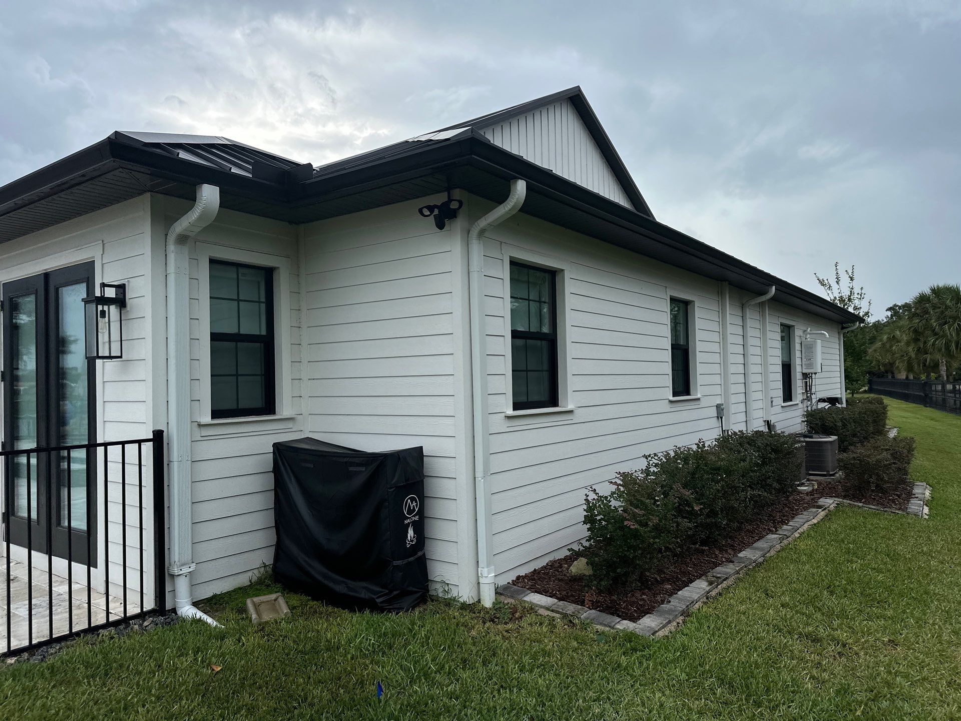Complete Two-Story House Wash and Driveway Cleaning in Winding River Community, Bradenton, FL by Sunshine AquaWash