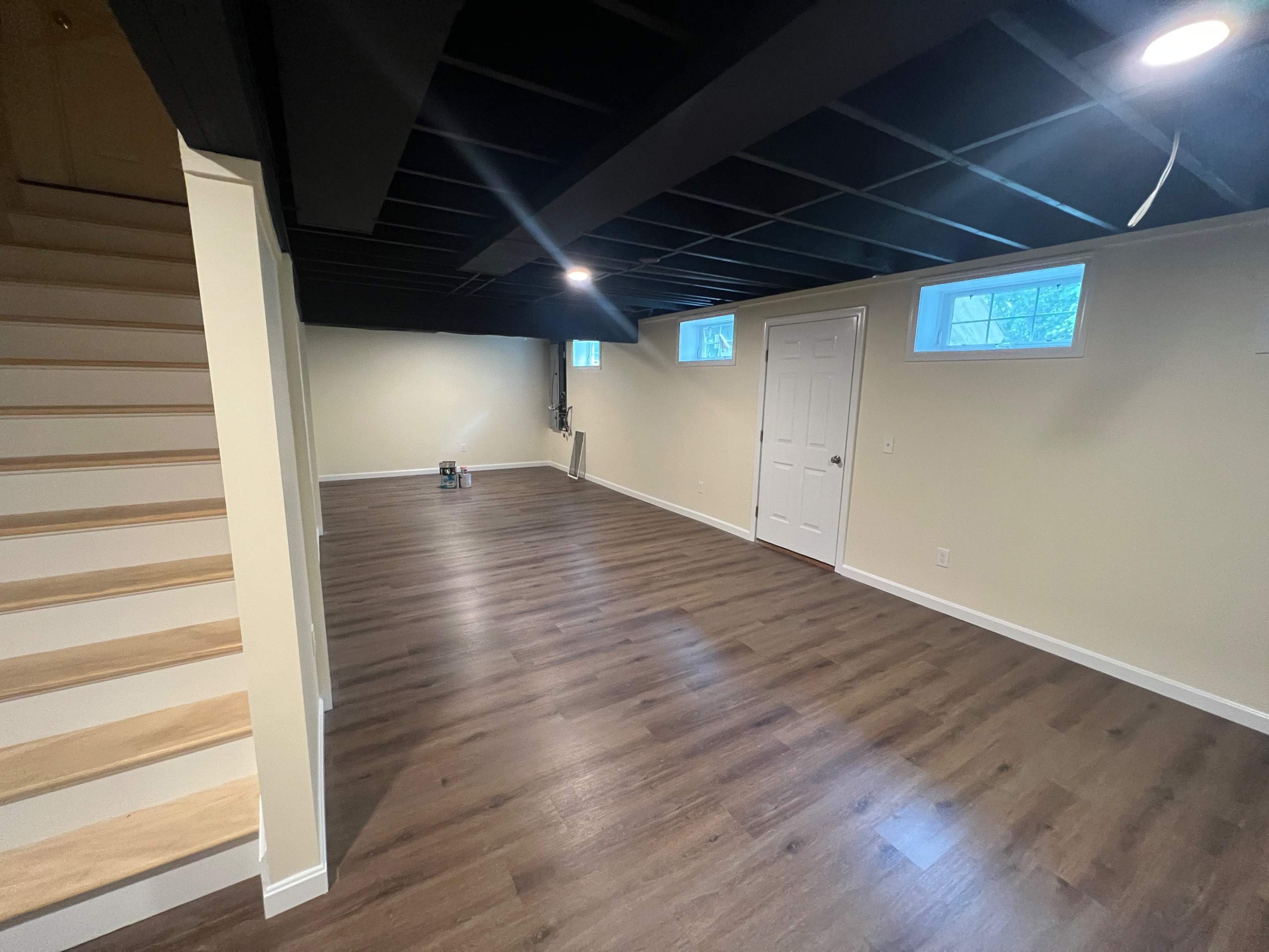 Basement Remodel w/ LVP Flooring & Exposed Ceiling by Chagnon Building & Remodeling LLC
