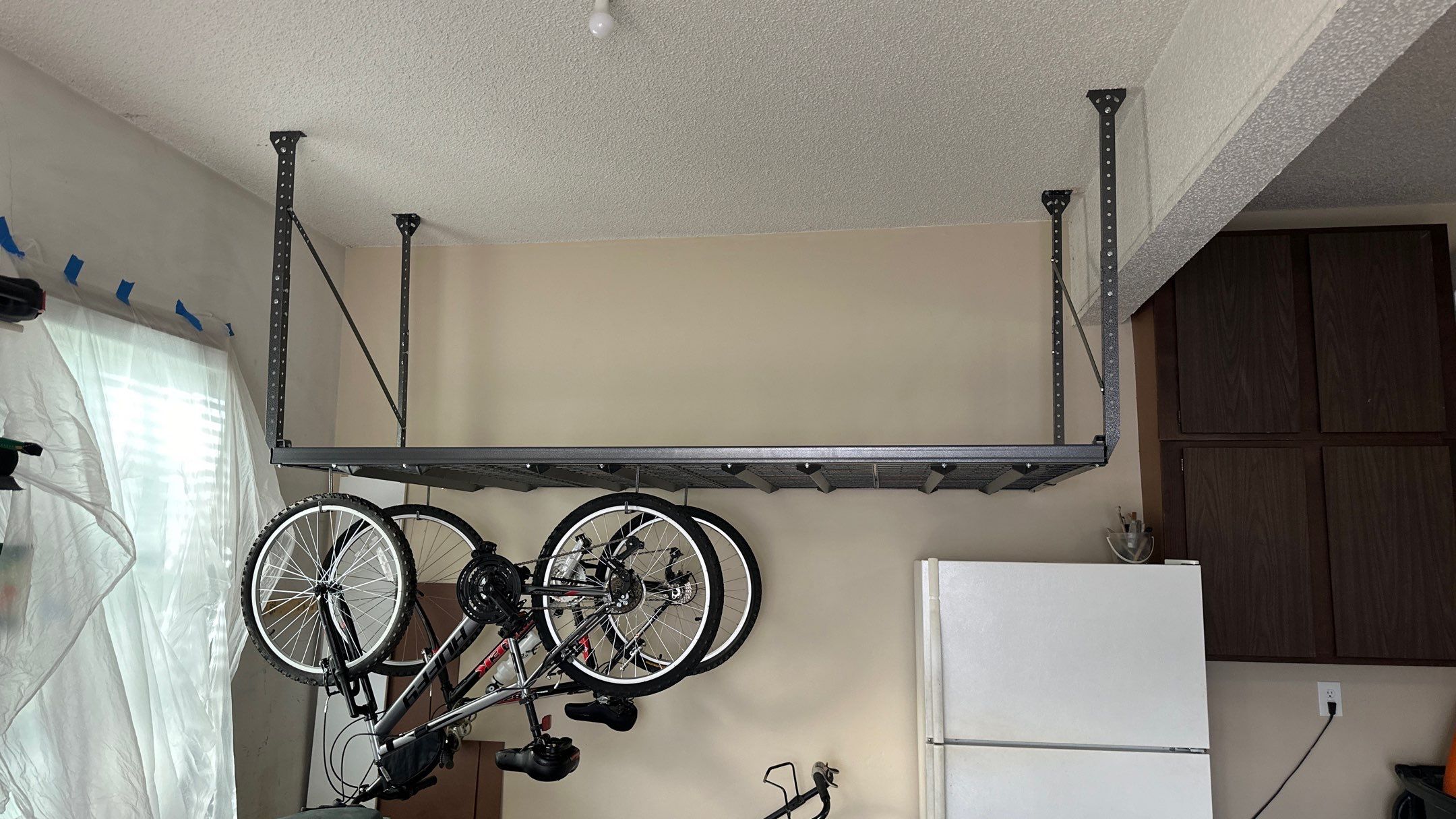 Kelly Q. added overhead racks to their garage  by Banner Garage