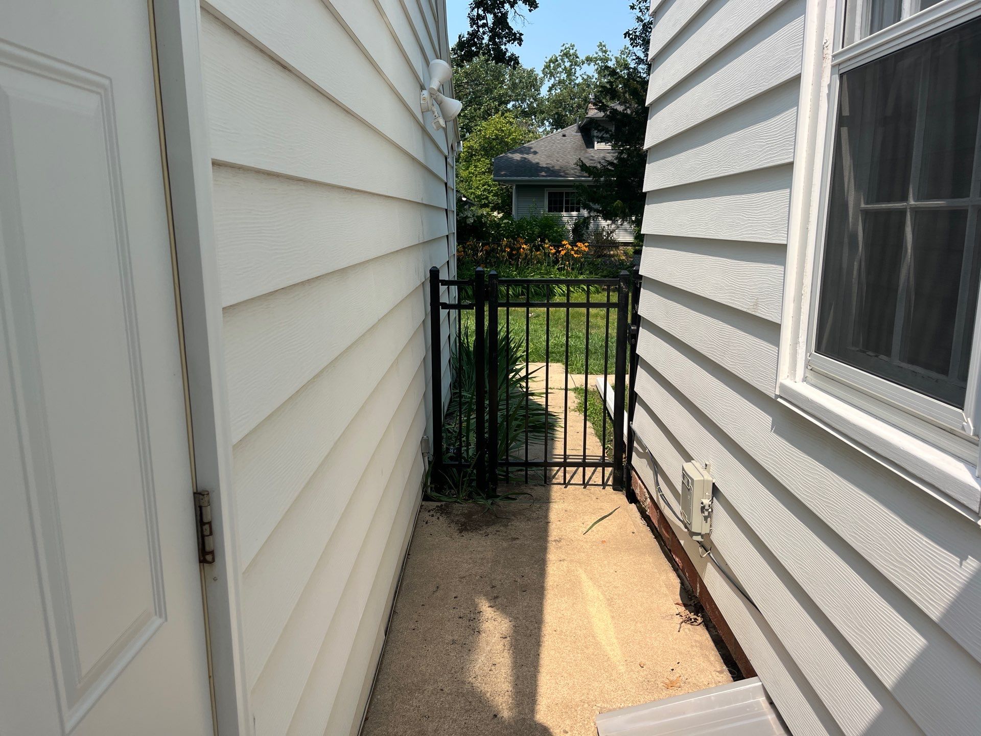 Residential Black Chain Link Fence Installation in Cedar Falls by Perfect Picket Fence and Stain