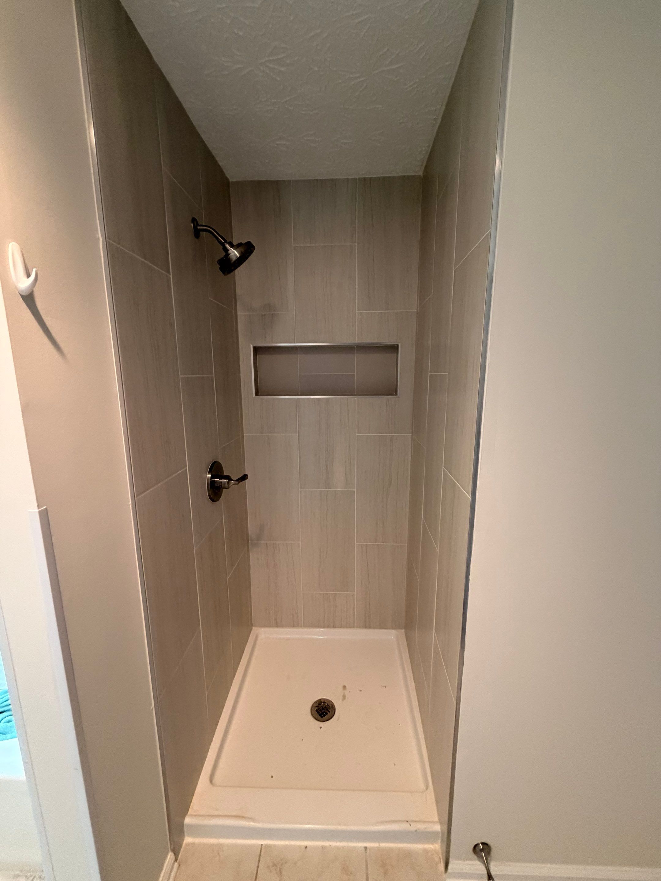 Custom Shower Renovation With Vertical Tile and Frameless Glass in Kennesaw by Swift Home Renovations