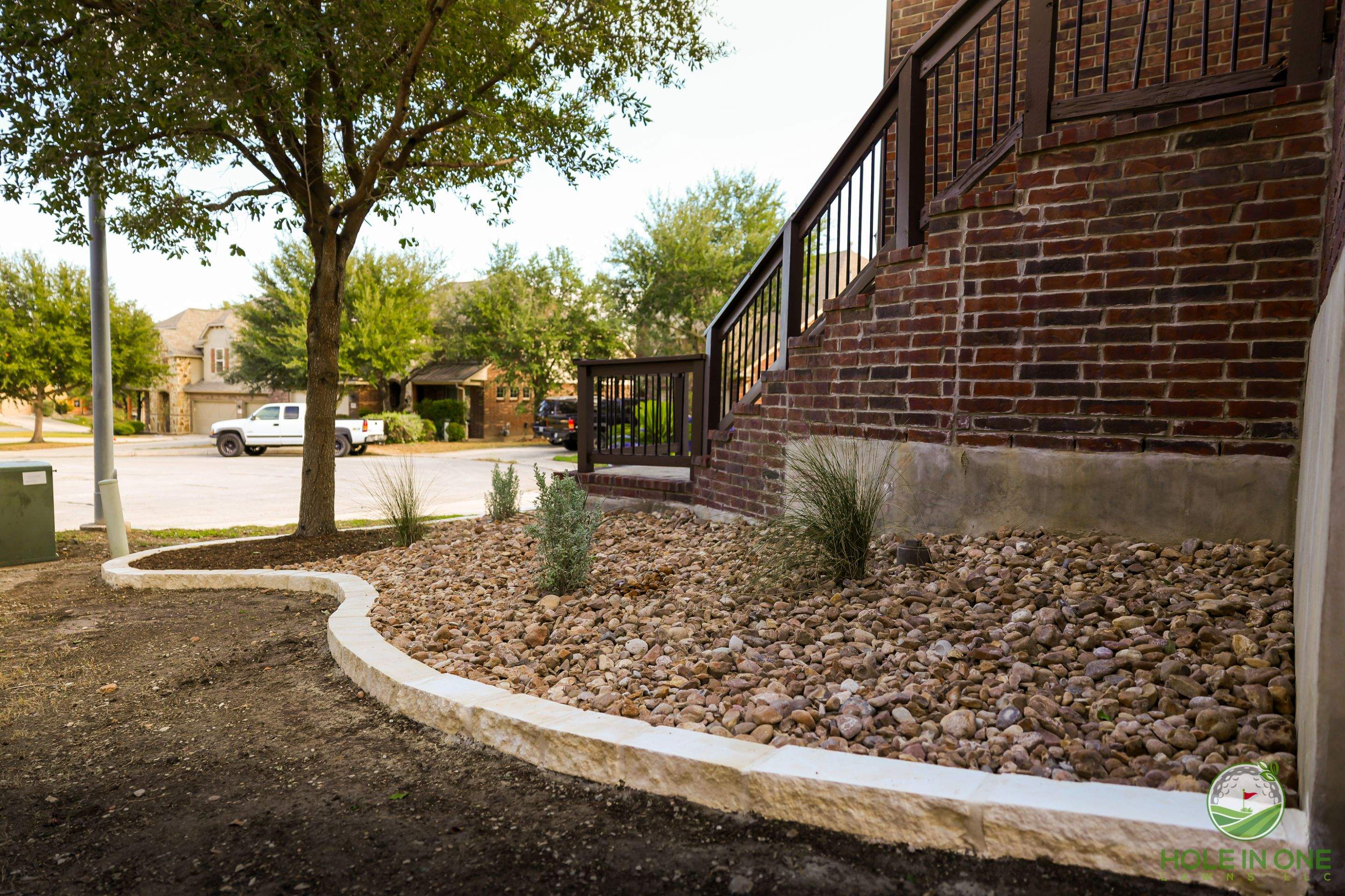 Low-Maintenance Front Yard Xeriscape with Chopstone Border, North San Antonio TX by Hole In One Lawns, LLC