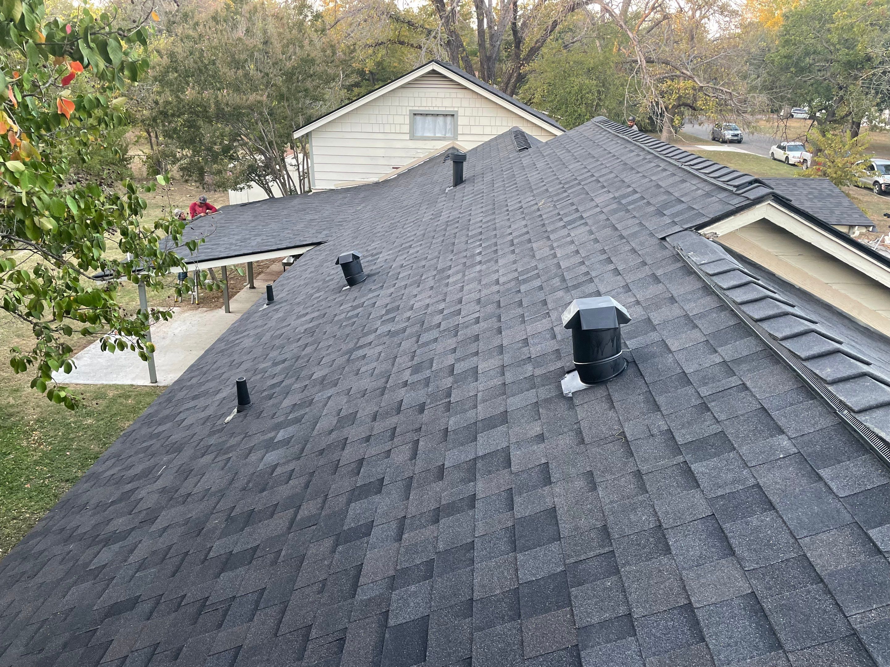 White exterior with IKO Glacier by Tejas Roofworks + Restoration