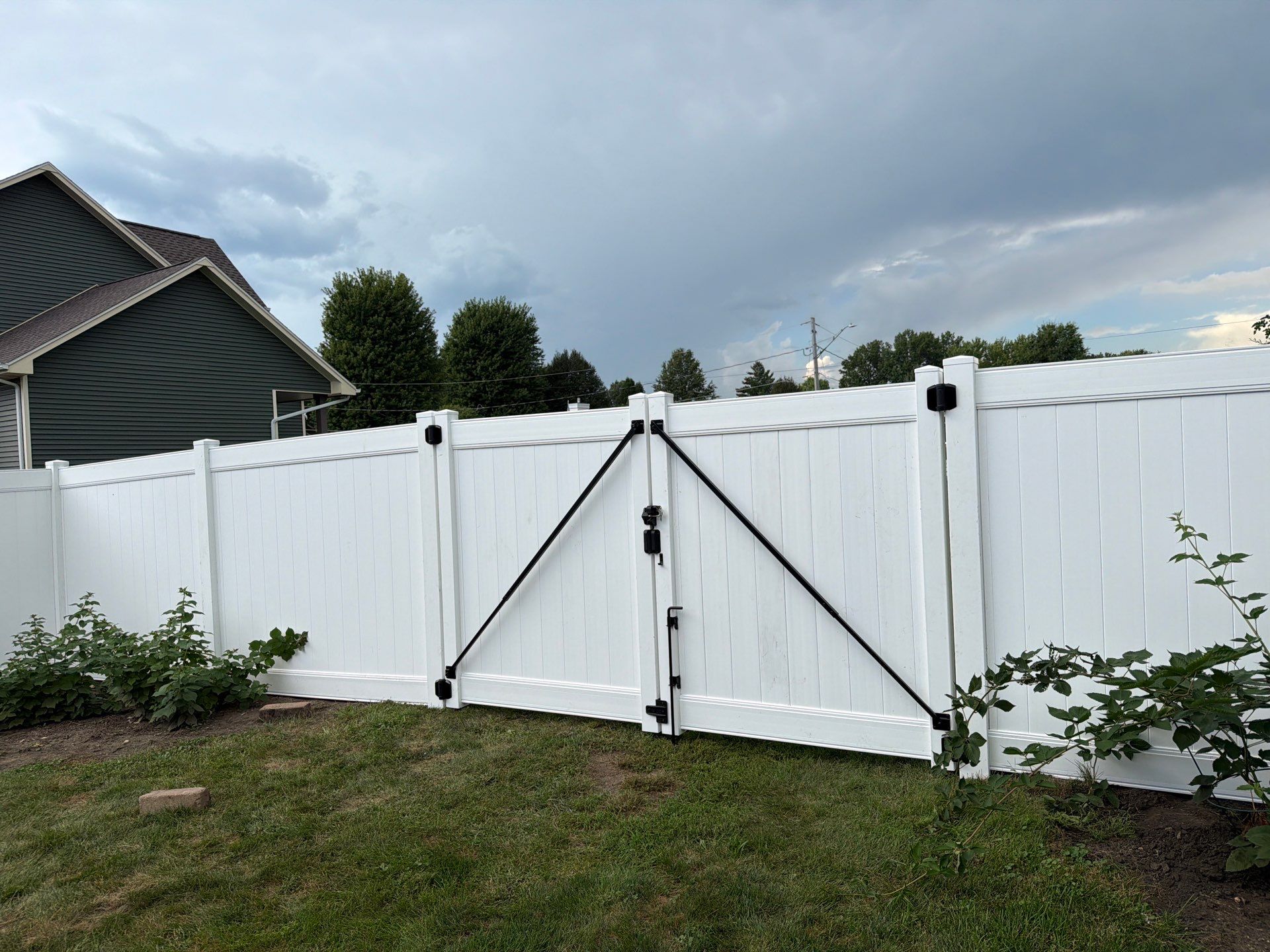 White Vinyl Privacy Fence Installation in Raymond, IA by Perfect Picket Fence and Stain