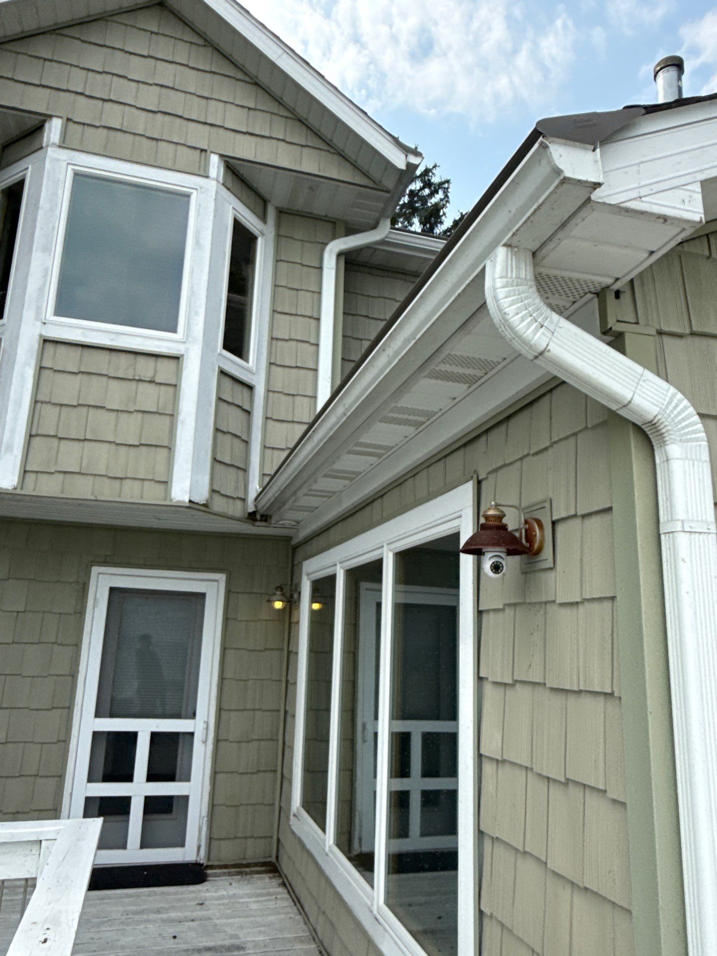 Gutter Helmet Protection System for Suttons Bay Home with Cedar Siding by Rainbow Seamless Systems