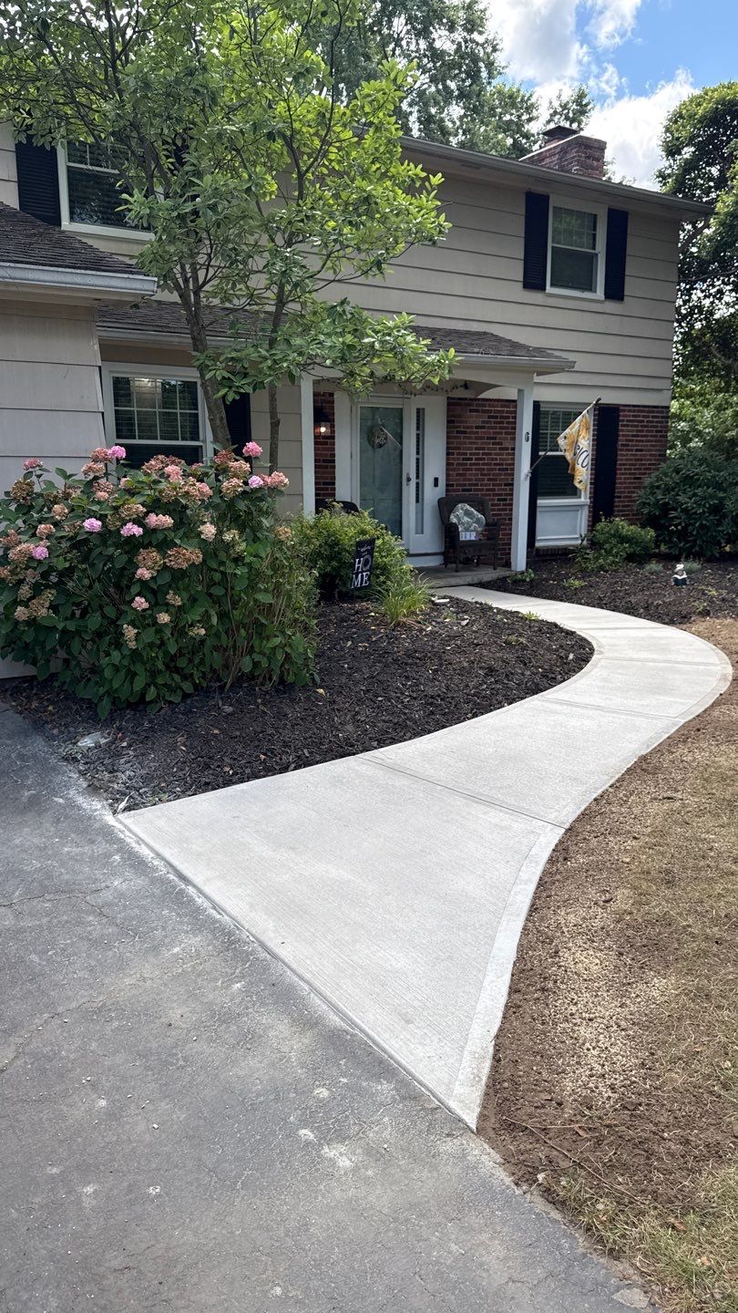 Broom finished concrete patio and sidewalk  by NG Masonry & Construction LLC