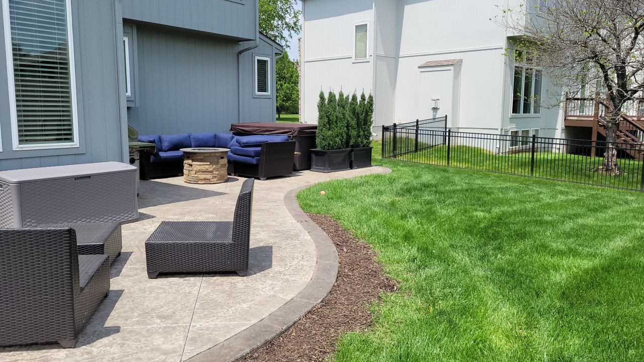 Back Yard Fireplace and Landscape by LAND ESCAPES LLC