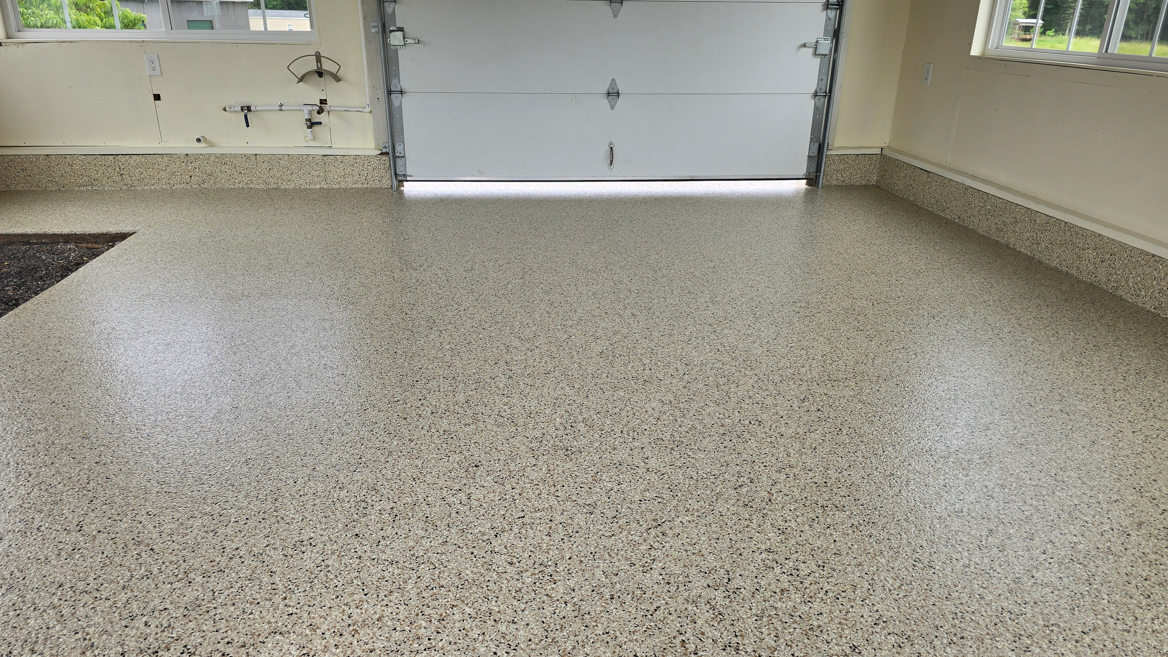 Two garages completed using Shoreline and Midnight by Elite Floor Solutions