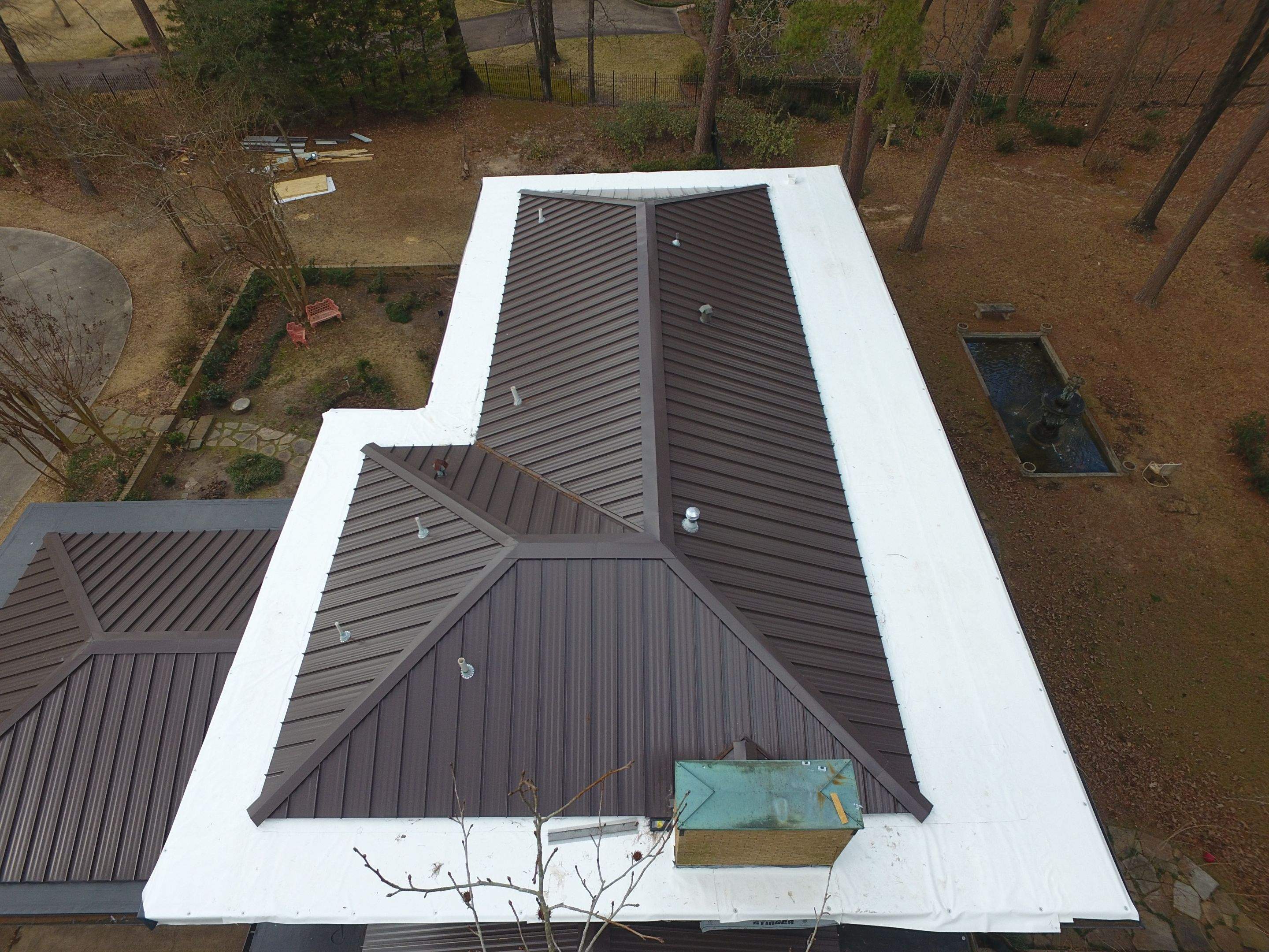 Residential Roofing Installation using PVC membrane and 24 gauge Standing Seam Metal by Hostetler Roofing