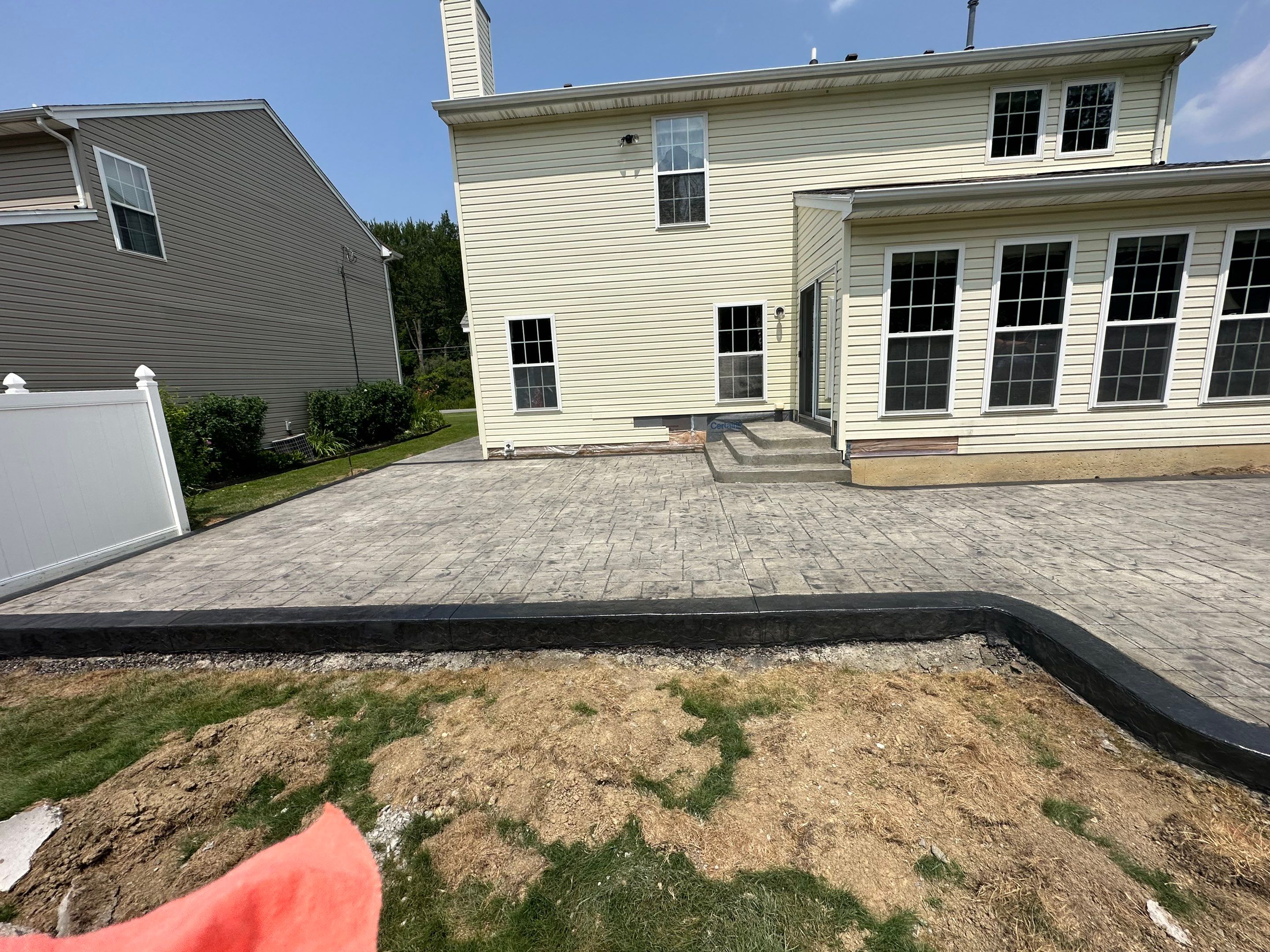 Stamped Concrete, Entry Door, and Concrete  by Ivy Lea Construction