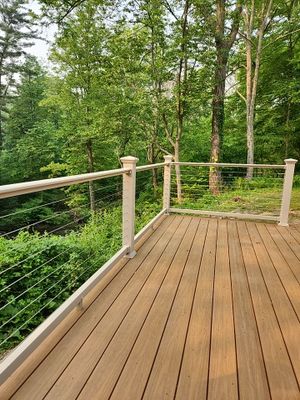 Deck installation using cable railing. 