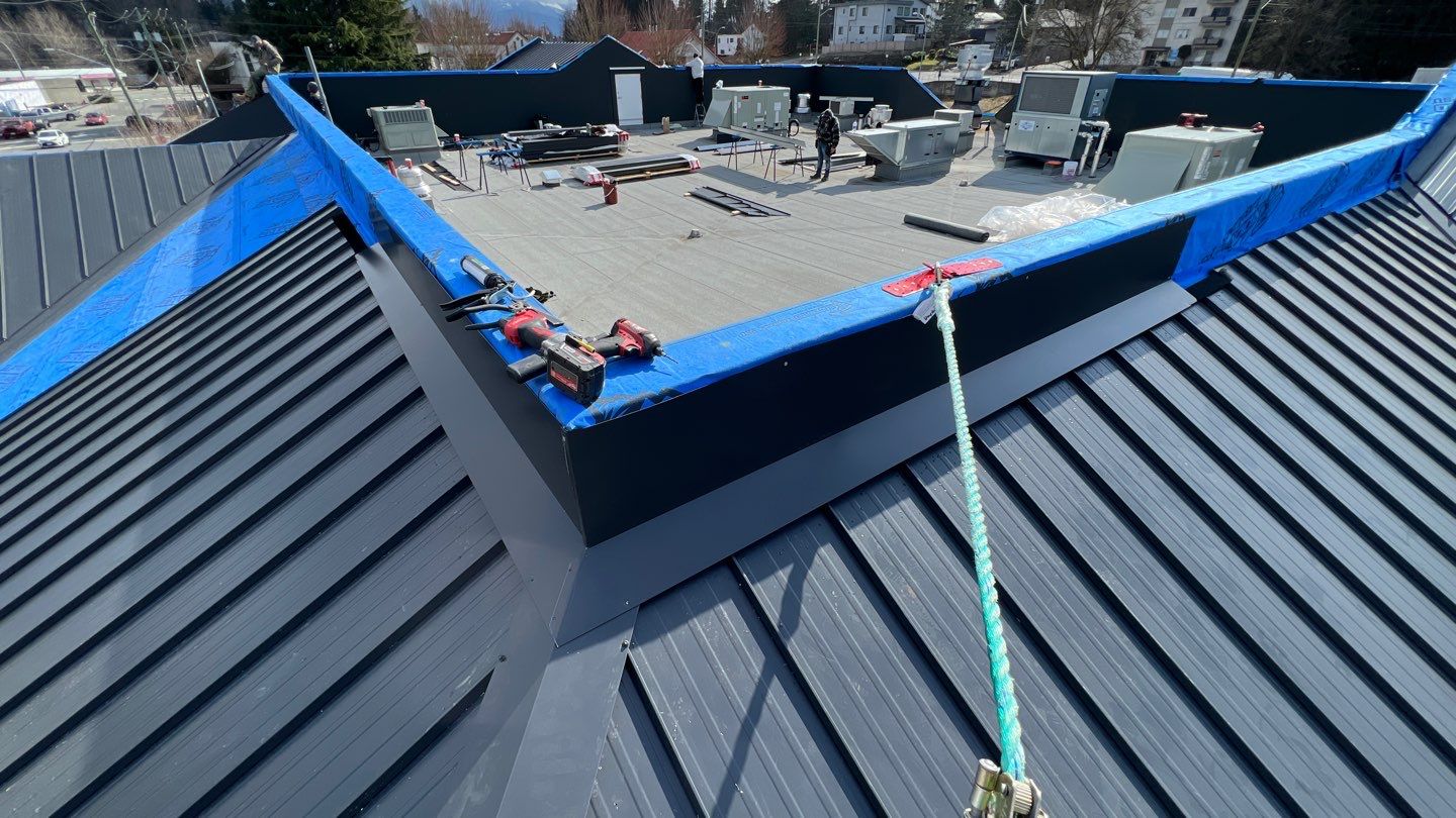 Commercial Roofing Installation using 12" Prolok metal and hidden gutters! by Top Notch Roofing Inc