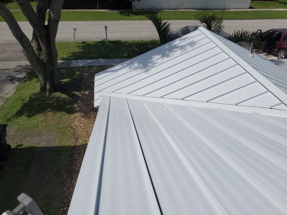 Residential Roofing Installation using 1.5" Nail Strip 24ga Solar White Kynar Coated Standing Seam Metal Panels by Morton Roofing, Inc.