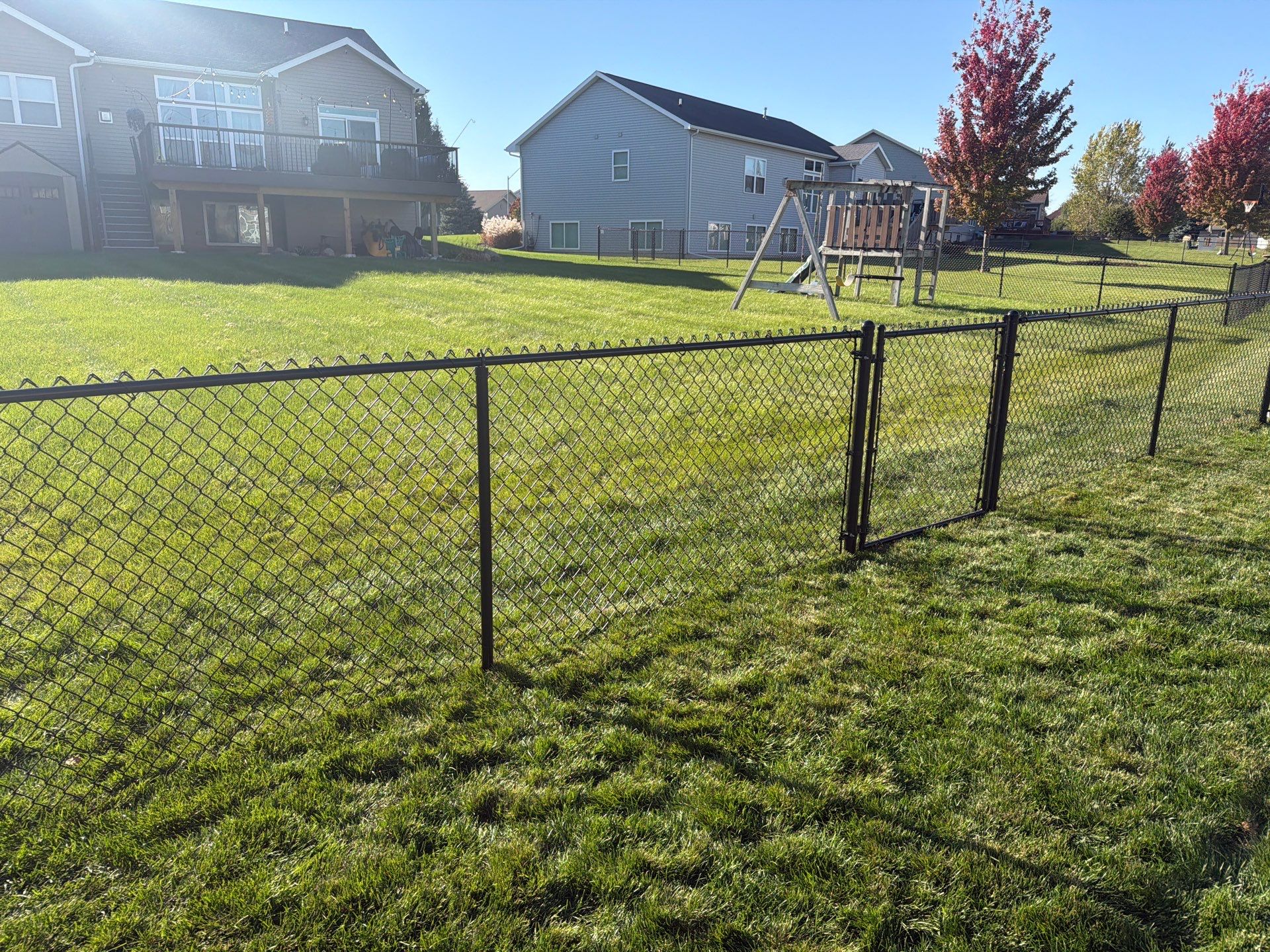 Black Vinyl-Coated Chain Link Fence Installation in Cedar Falls by Perfect Picket Fence and Stain