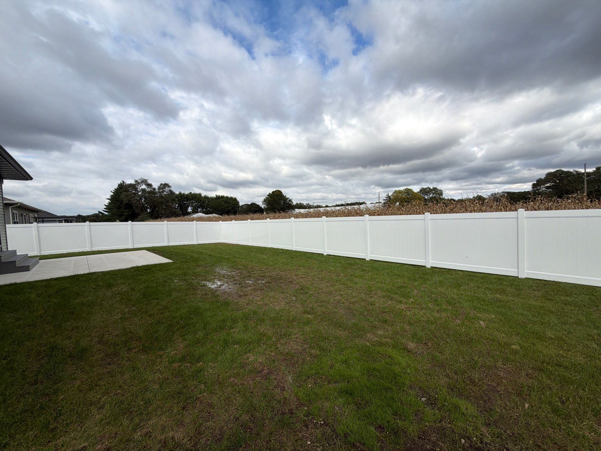 Residential White Vinyl Privacy Fence Installation in Janesville by Perfect Picket Fence and Stain