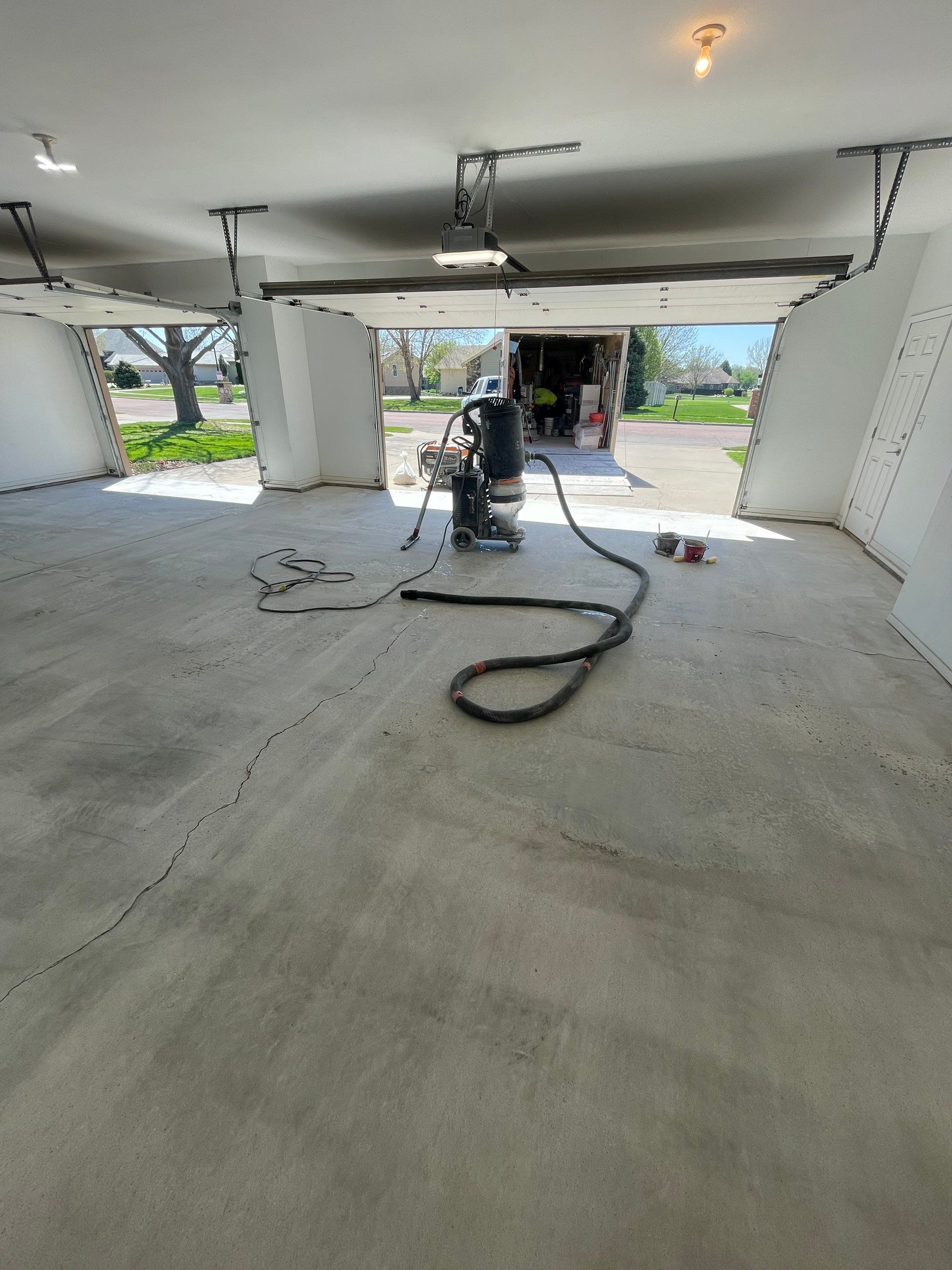 Yankton Garage Floor Restoration with Gray Speckled Epoxy Coating by Select Painting, Coatings & Garage Cabinets