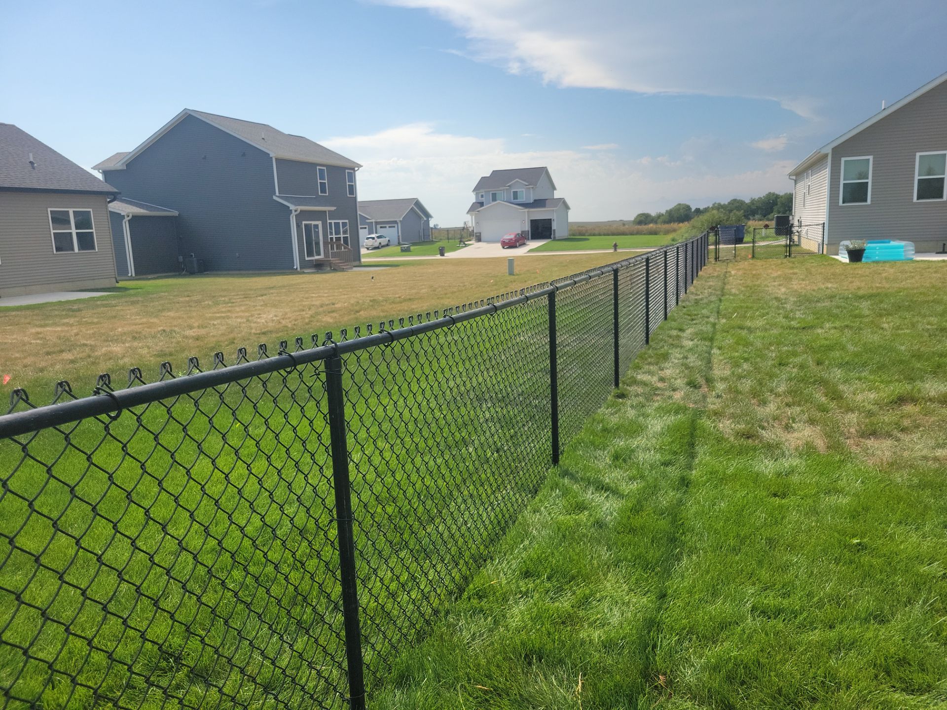 Residential Black Chain Link Fence Installation in Jesup by Perfect Picket Fence and Stain